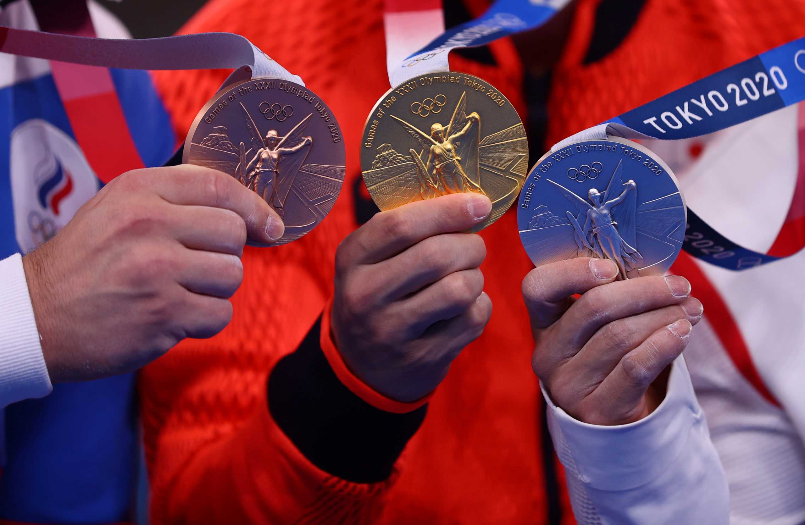 Tokyo 2020 Olympics - Gymnastics - Artistic - Men's Individual All-Around - Medal Ceremony - Ariake Gymnastics Centre, Tokyo, Japan - July 28, 2021.  Gold medallist Daiki Hashimoto of Japan, silver medallist Xiao Ruoteng of China and bronze medallist Nikita Nagornyy of the Russian Olympic Committee pose with medals. REUTERS