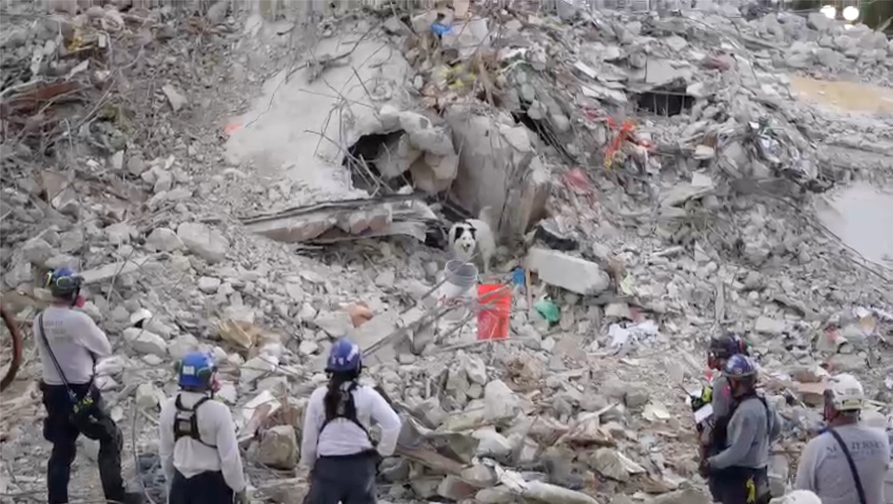 Search-and-rescue personnel work on the debris of the collapsed Champlain Towers South condominium in Surfside, Florida, U.S., July 5, 2021, in this still image obtained from video. Courtesy of  Miami-Dade Fire Rescue Department