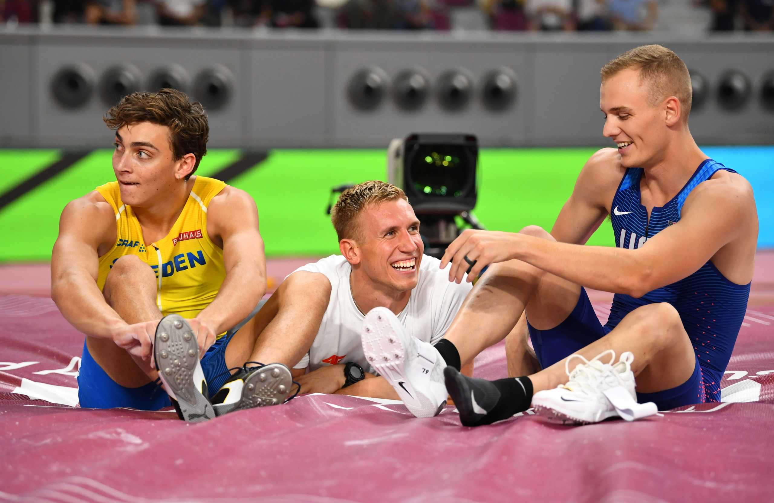 FILE PHOTO: World Athletics Championships Men's Pole Vault Gold medalist Sam Kendricks of the U.S., silver medalist Sweden's Armand Duplantis and bronze medalist Poland's Piotr Lisek talk at Khalifa International Stadium, Doha, Qatar - October 1, 2019. REUTERS