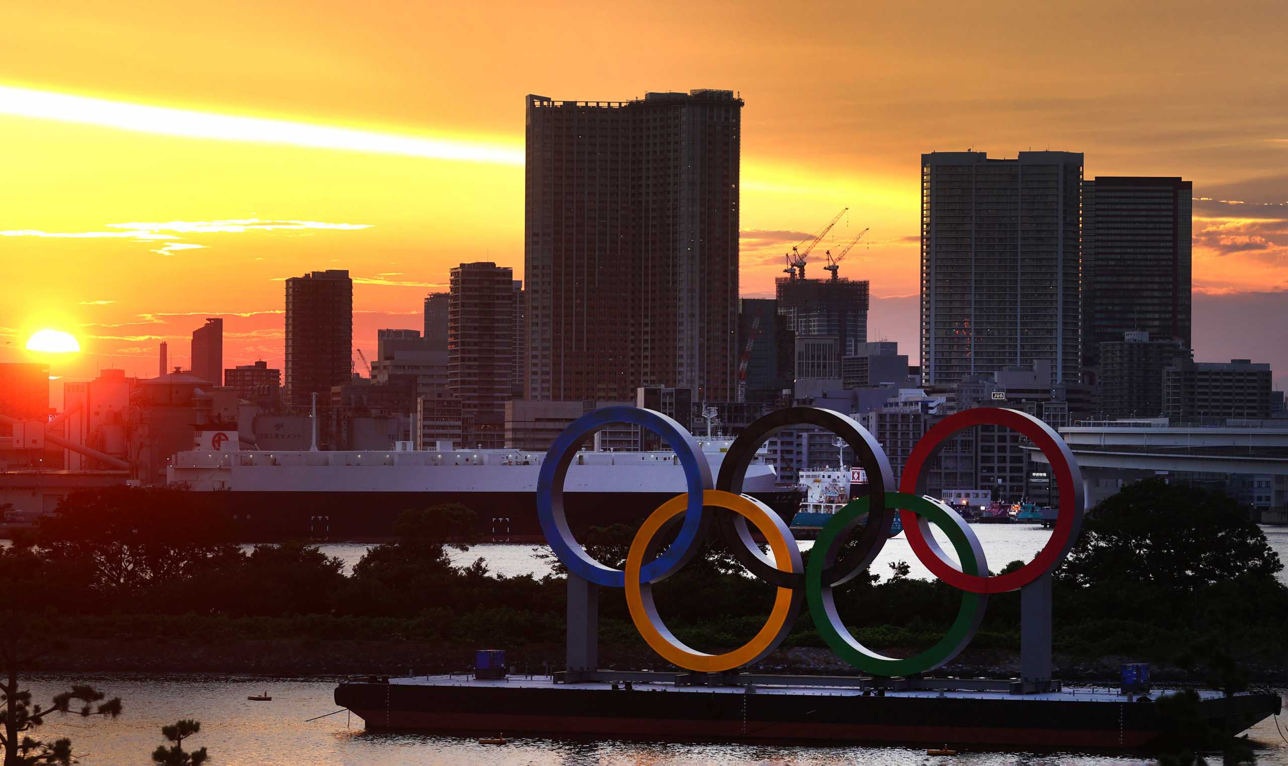The Olympic Rings are seen in front of the skyline during sunset, three days ahead of the official opening of the Tokyo 2020 Olympic Games, in Tokyo, Japan, July 20, 2021.   REUTERS