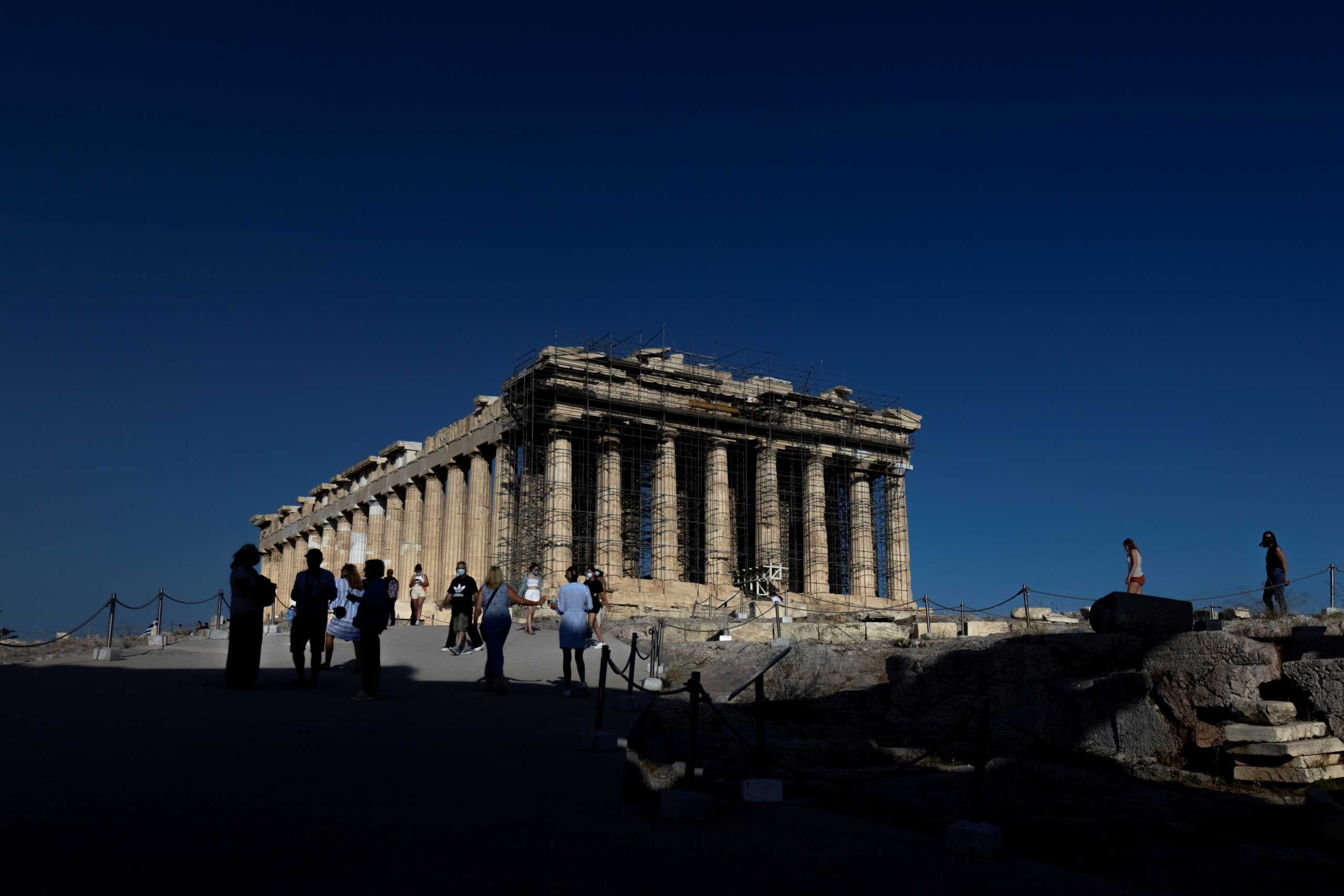 FILE PHOTO: People visit the Parthenon temple atop the Acropolis hill in Athens, Greece, June 8, 2021. Picture taken June 8, 2021. REUTERS