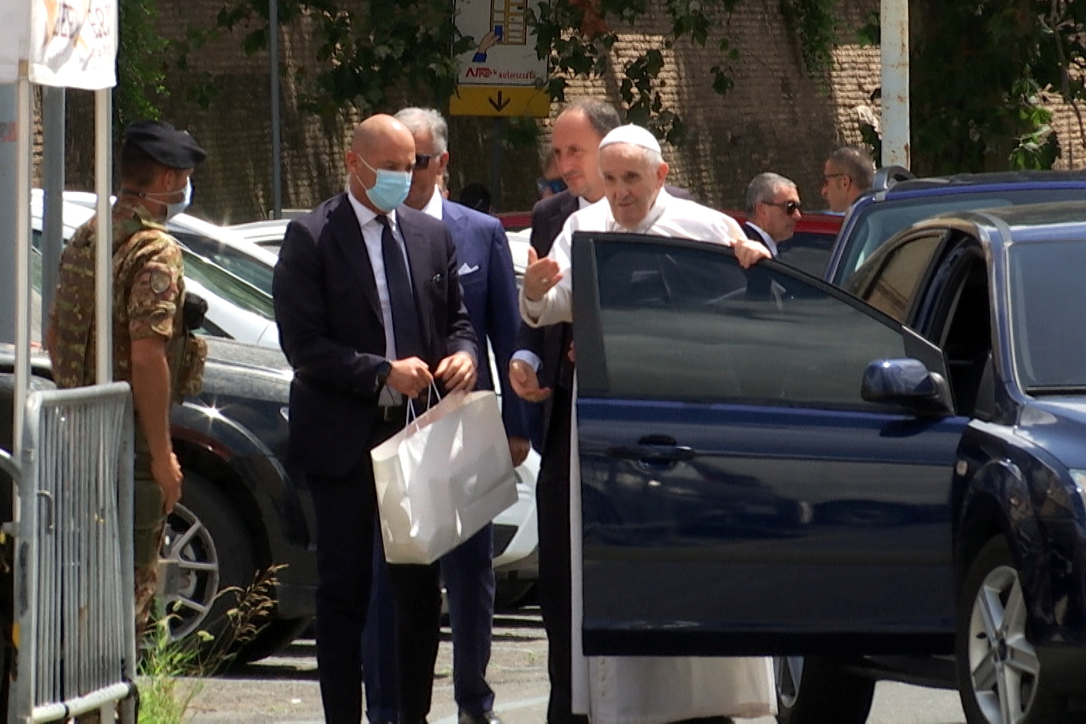 Pope Francis leaves the car to greet policemen before entering the Vatican after being discharged from Gemelli hospital in this screengrab taken from a video in Rome, Italy, July 14, 2021. Cristiano Corvino