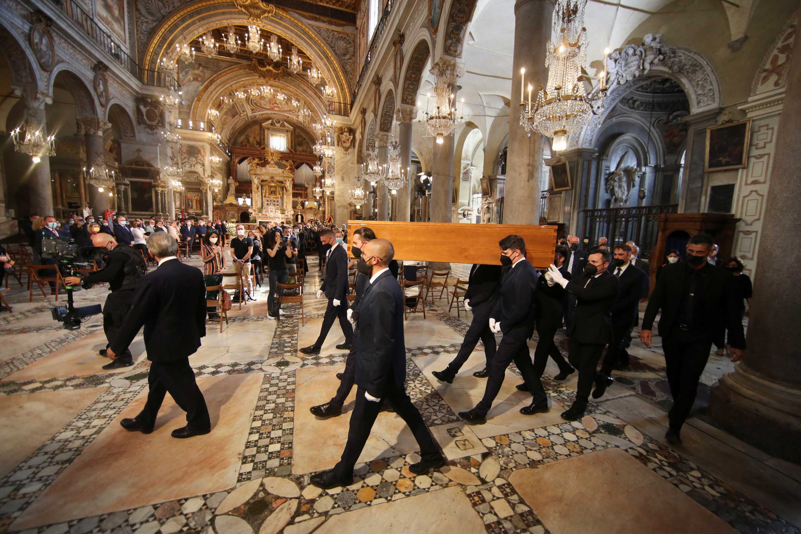 Coffin carrying Raffaella Carra, one of Italy's best-loved singers and television presenters, who became famous as a symbol of sexual liberation, is carried into Basilica of St. Mary of the Altar of Heaven before her funeral, in Rome, Italy, July 9, 2021. REUTERS