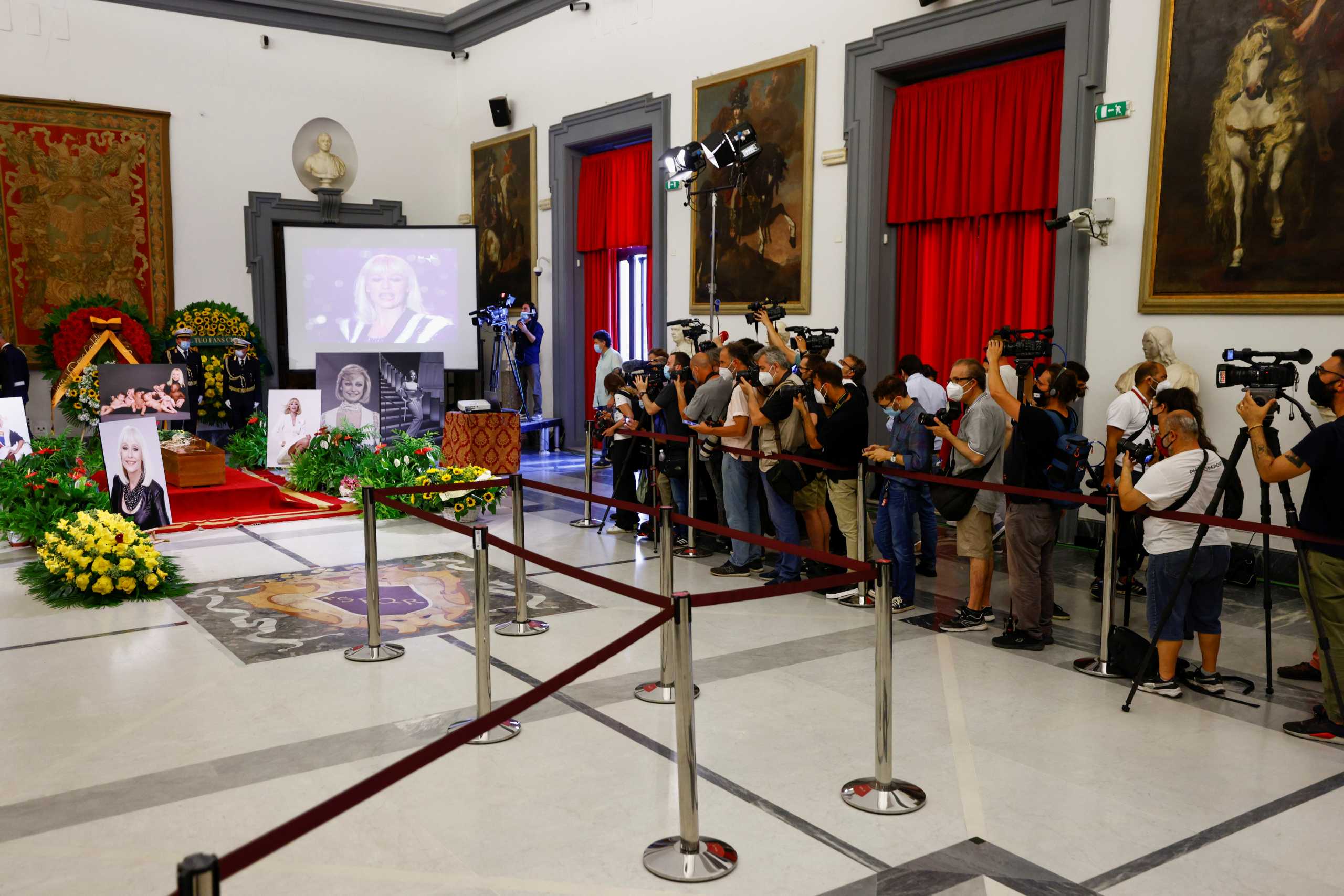 Members of the media record and picture a coffin of Raffaella Carra, one of Italy's best-loved singers and television presenters at Protomoteca hall at the Campidoglio square in Rome, Italy, July 7, 2021. REUTERS