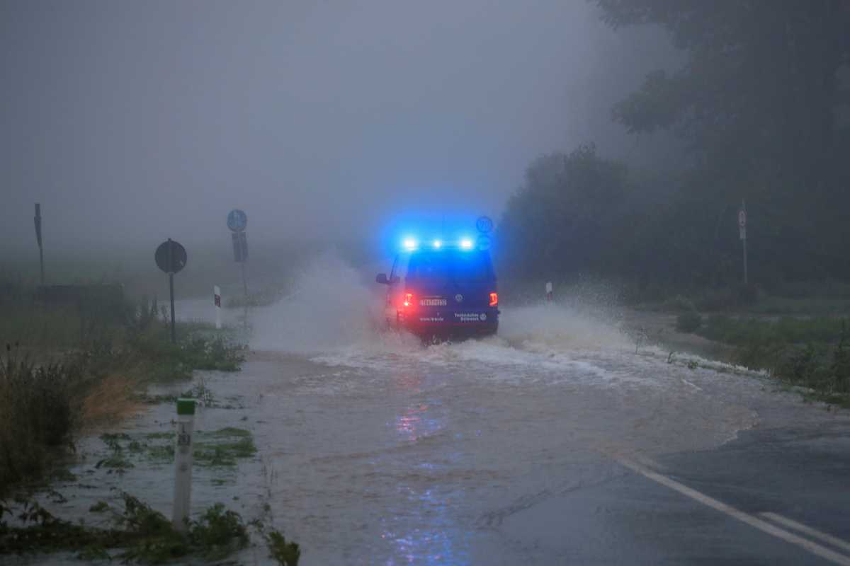 A vehicle travels on a flood affected road after the Erft river swelled following heavy rainfalls in Erftstadt, near Cologne, Germany, July 15, 2021. REUTERS