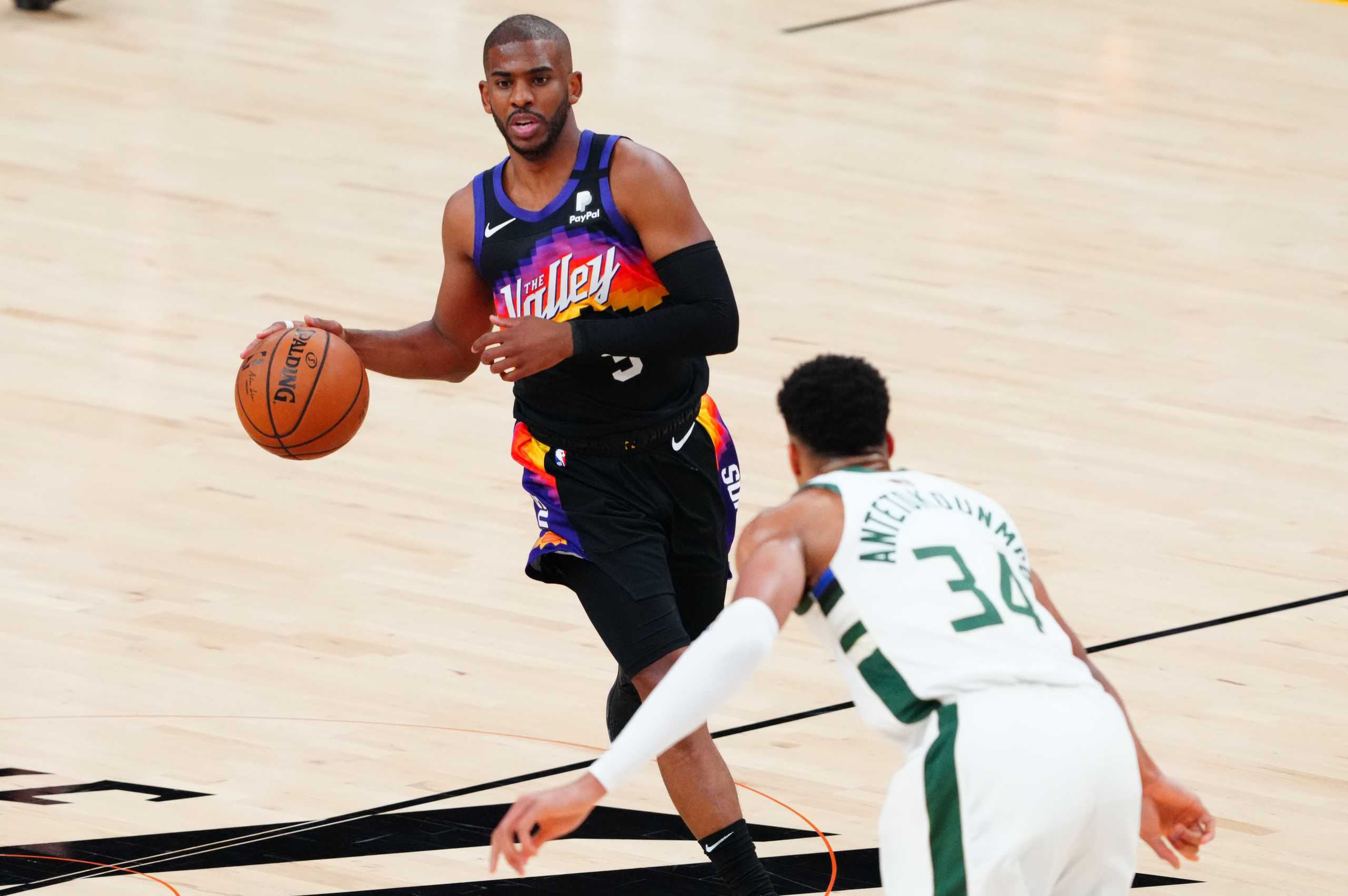 Jul 6, 2021; Phoenix, Arizona, USA; Phoenix Suns guard Chris Paul (3) moves the ball against Milwaukee Bucks forward Giannis Antetokounmpo (34) during the first half in game one of the 2021NBA Finals at Phoenix Suns Arena. Mandatory Credit: Mark J. Rebilas-USA TODAY Sports