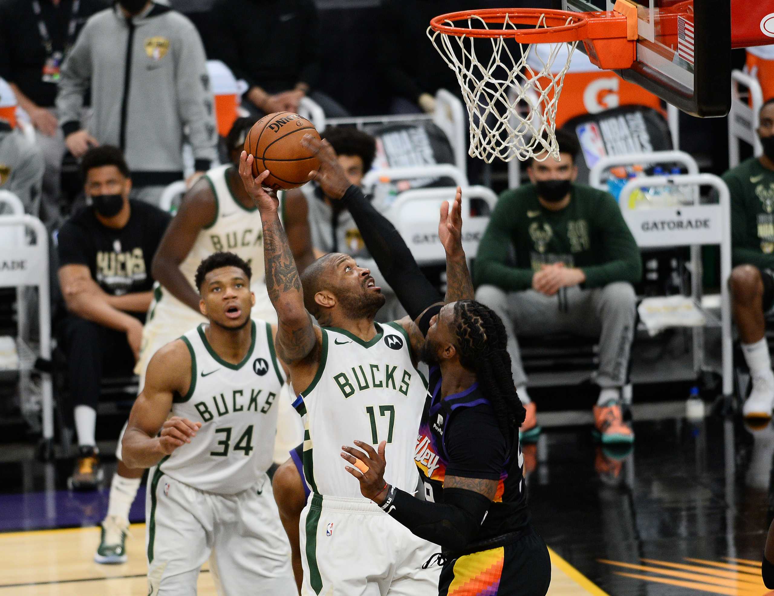 Jul 6, 2021; Phoenix, Arizona, USA; Milwaukee Bucks forward P.J. Tucker (17) moves to the basket agianst Phoenix Suns forward Jae Crowder (99) during the second half in game one of the 2021 NBA Finals at Phoenix Suns Arena. Mandatory Credit: Joe Camporeale-USA TODAY Sports