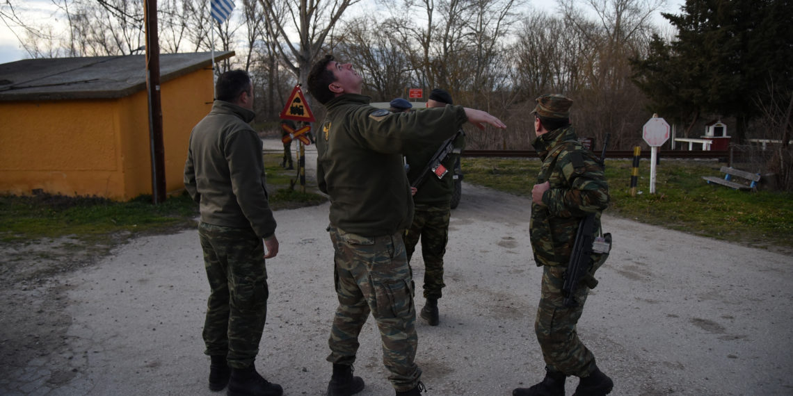 A Greek soldier flies a drone, to spot migrants and refugees crossing from Turkey into Greece, near the village of Marasia, Greece, February 28, 2020. REUTERS