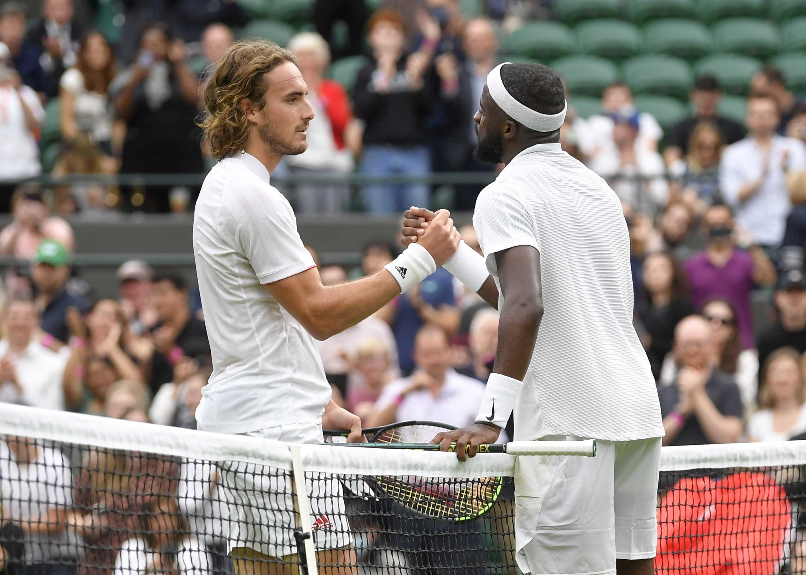 Tennis - Wimbledon - All England Lawn Tennis and Croquet Club, London, Britain - June 28, 2021 Frances Tiafoe of the U.S. shakes hands with Greece's Stefanos Tsitsipas after winning their first round match REUTERS