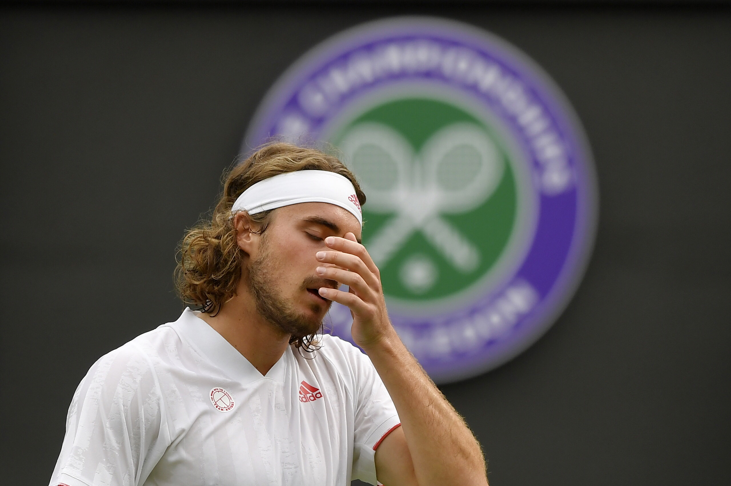 Tennis - Wimbledon - All England Lawn Tennis and Croquet Club, London, Britain - June 28, 2021 Greece's Stefanos Tsitsipas reacts during his first round match against Frances Tiafoe of the U.S. REUTERS