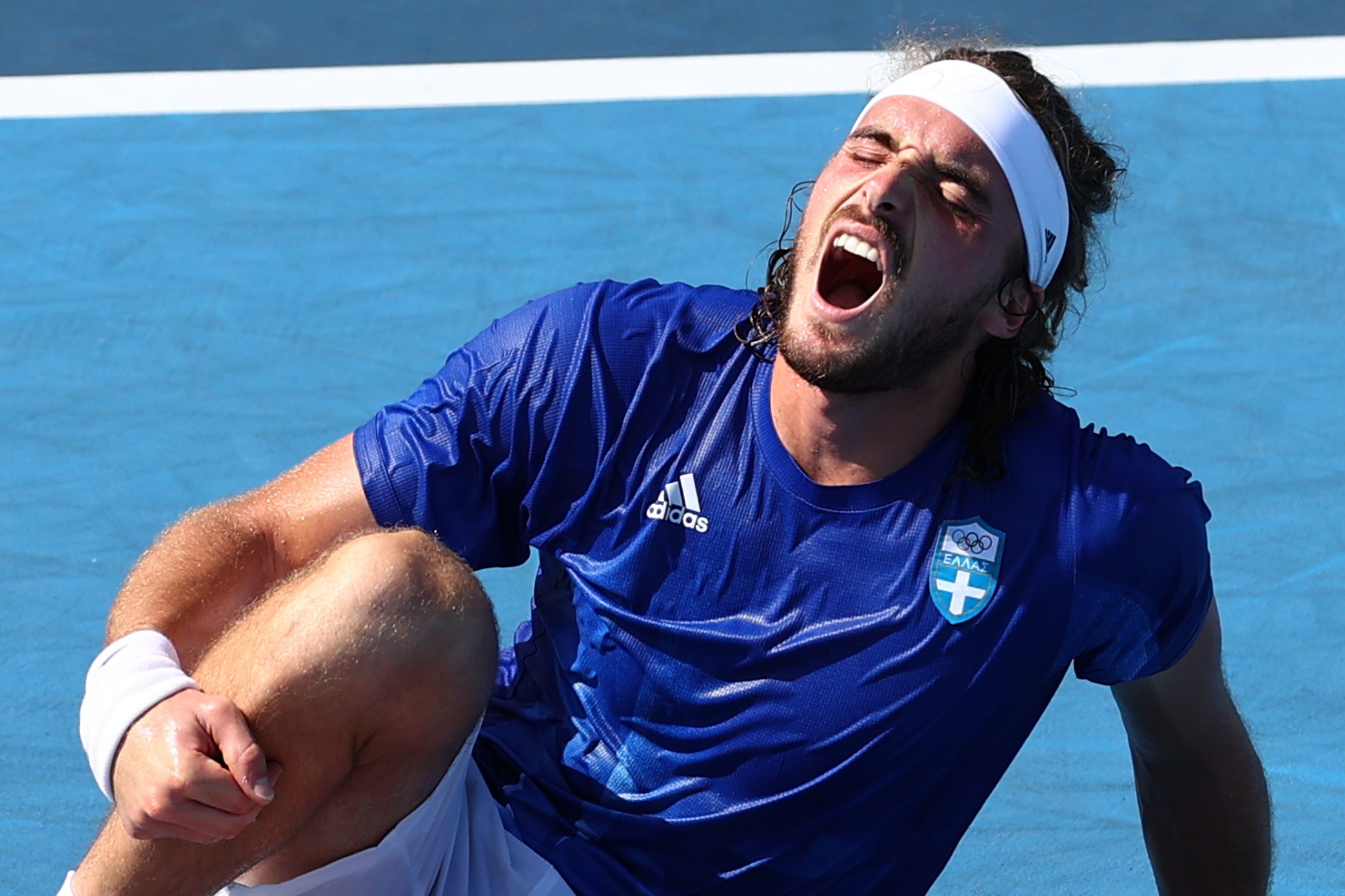 Tokyo 2020 Olympics - Tennis - Men's Singles - Round 3 - Ariake Tennis Park - Tokyo, Japan - July 28, 2021. Stefanos Tsitsipas of Greece sustains an injury during his third round match against Ugo Humbert of France REUTERS