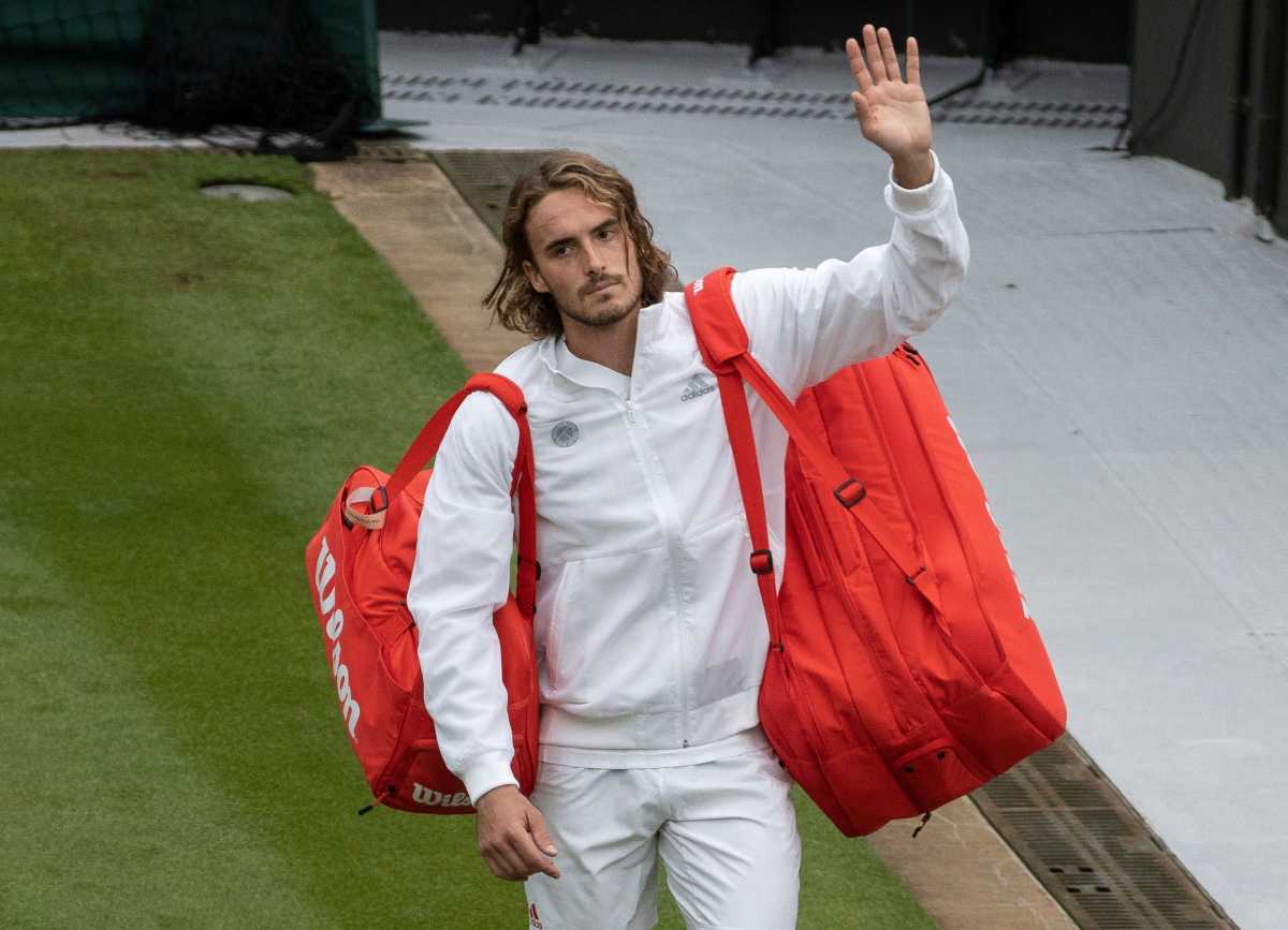 Tennis - Wimbledon - All England Lawn Tennis and Croquet Club, London, Britain - June 28, 2021 Greece's Stefanos Tsitsipas looks dejected as he walks off court after losing his first round match against Frances Tiafoe of the U.S. Pool via REUTERS