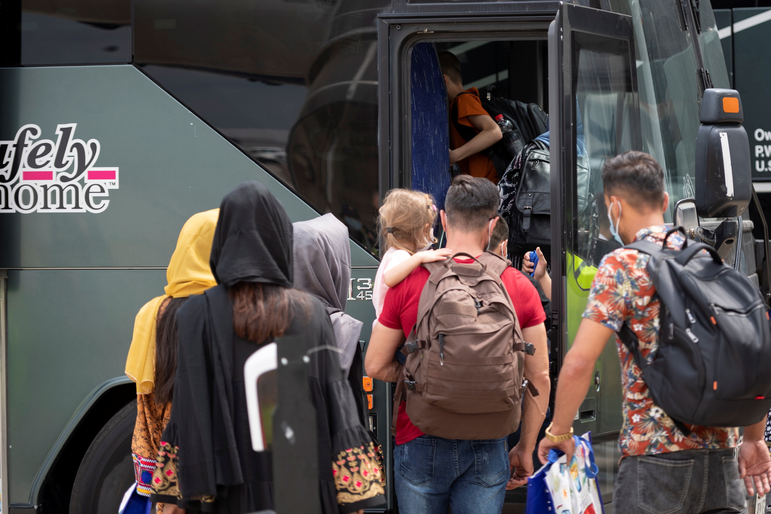 Afghan refugees who supported Canada’s mission in Afghanistan wait to board buses after arriving in Canada at Toronto Pearson International Airport in Mississauga, Ontario, Canada August 13, 2021. Picture taken August 13, 2021.  Cpl Rachael Allen