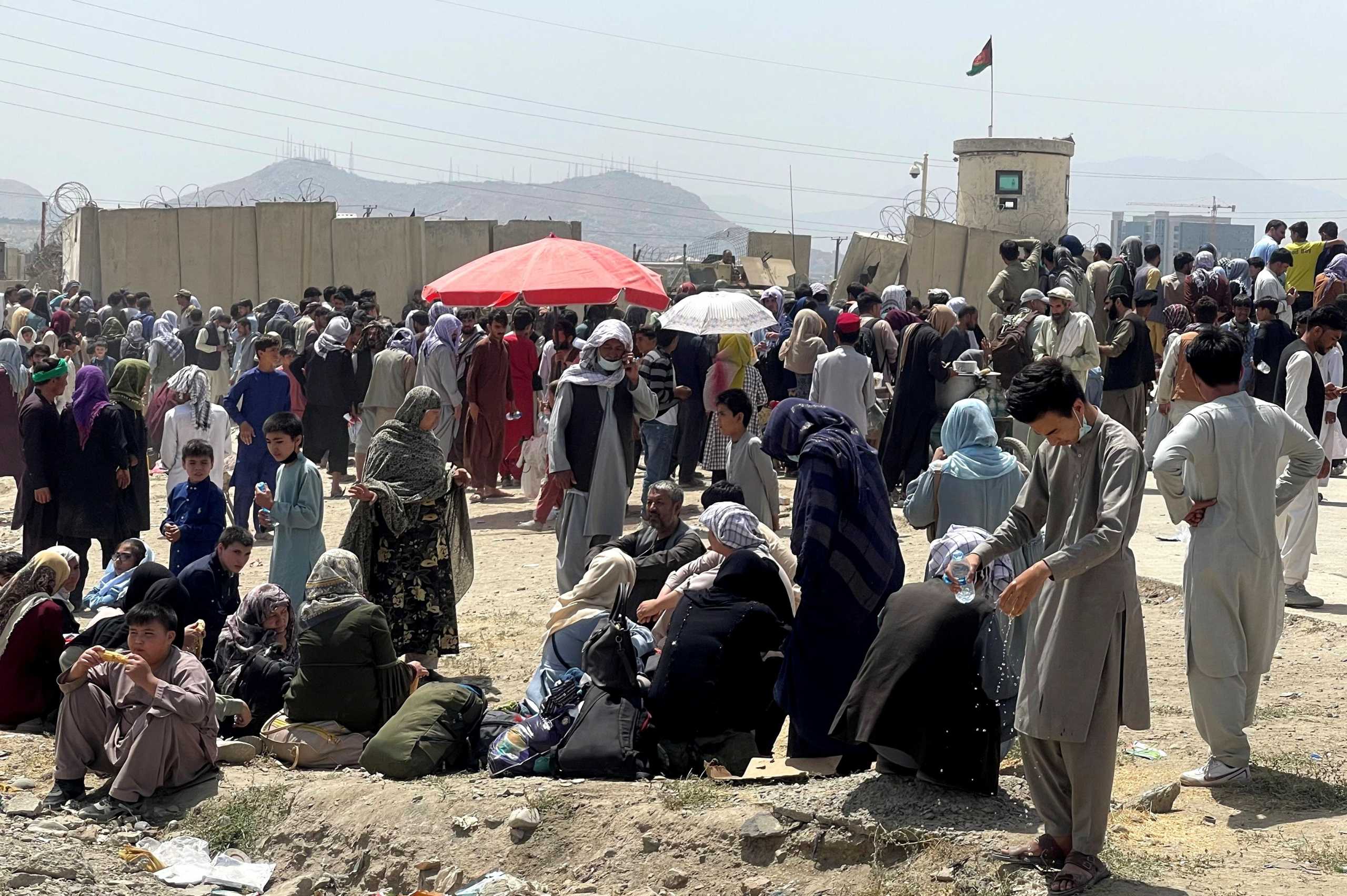 People wait outside Hamid Karzai International Airport in Kabul, Afghanistan August 17, 2021. REUTERS