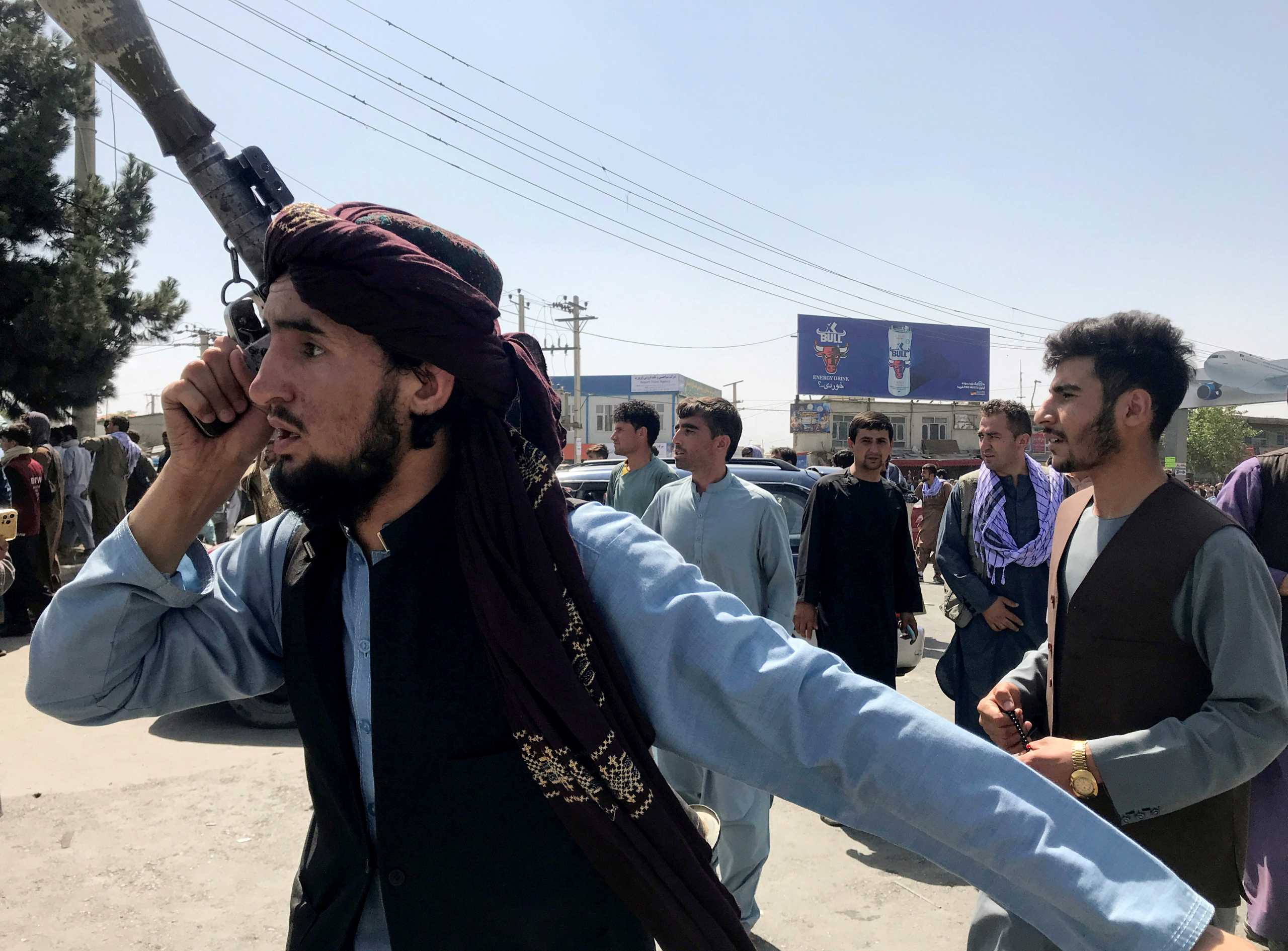 A member of Taliban forces inspects the area outside Hamid Karzai International Airport in Kabul, Afghanistan August 16, 2021. REUTERS