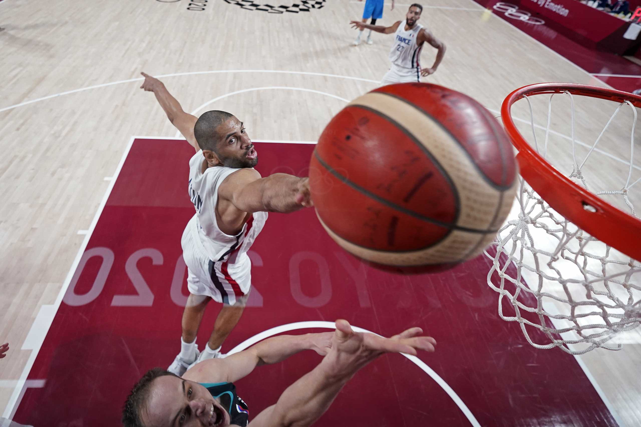 Tokyo 2020 Olympics - Basketball - Men - Semifinal - France v Slovenia - Saitama Super Arena, Saitama, Japan - August 5, 2021. Klemen Prepelic of Slovenia is blocked by Nicolas Batum of France Pool via REUTERS