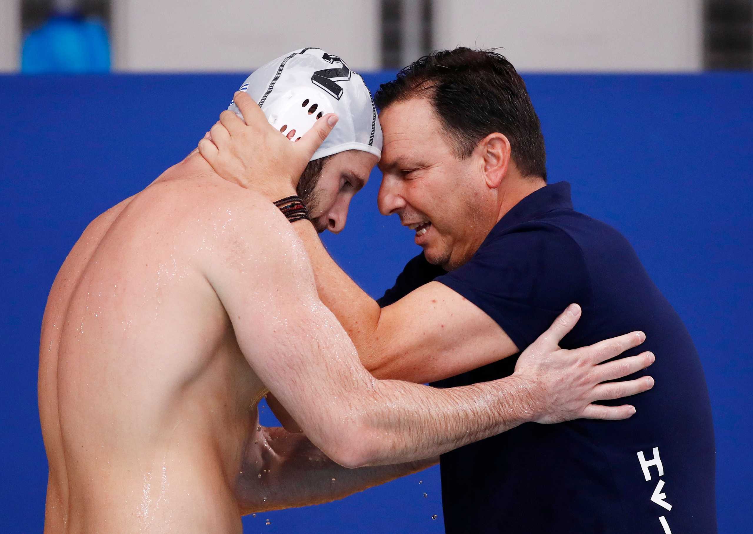 Tokyo 2020 Olympics - Water Polo - Men - Quarterfinal - Greece v Montenegro - TWC - Tatsumi Water Polo Centre, Tokyo, Japan - August 4, 2021. Greece's head coach Theodoros Vlachos celebrate with Konstantinos Genidounias of Greece. REUTERS