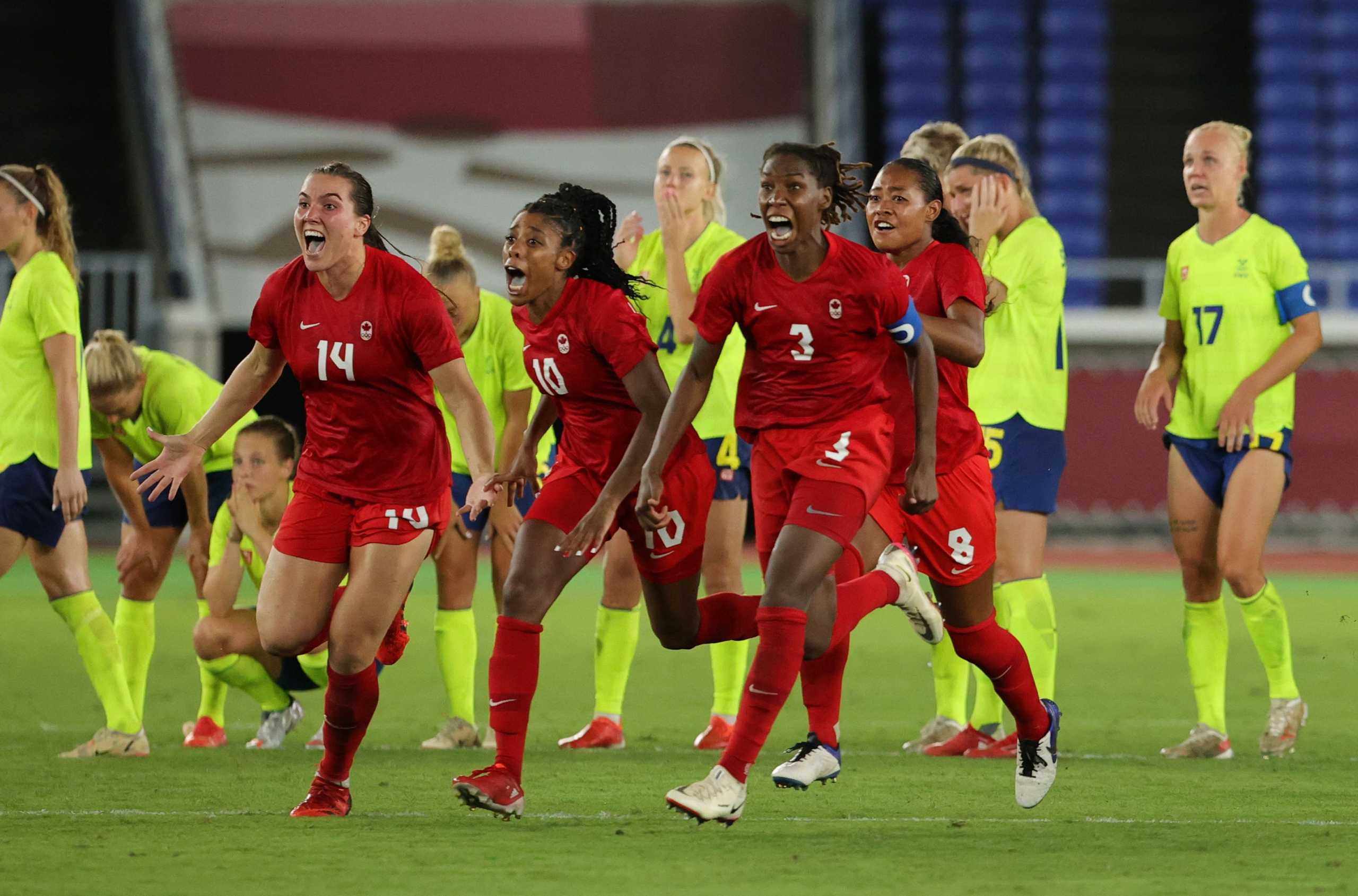 Tokyo 2020 Olympics - Soccer Football - Women - Gold medal match - Sweden v Canada - International Stadium Yokohama, Yokohama, Japan - August 6, 2021. Kadeisha Buchanan of Canada , Vanessa Gilles of Canada  and Jayde Riviere of Canada celebrate winning the penalty shootout and the gold medal. REUTERS