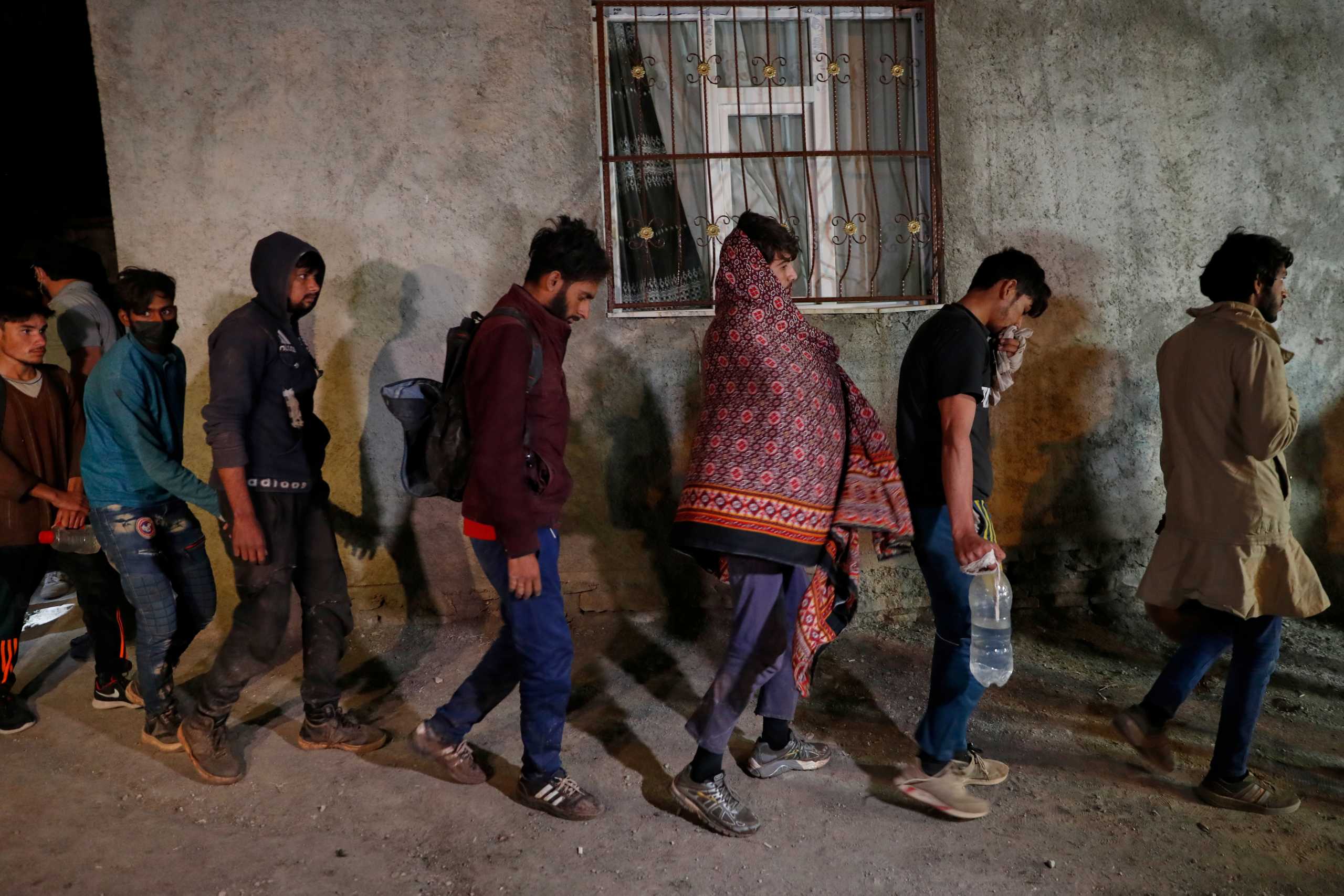Migrants, mainly from Afghanistan, are seen after they were detained by Turkish security forces during an operation in the border city of Van, Turkey late August 21, 2021. REUTERS