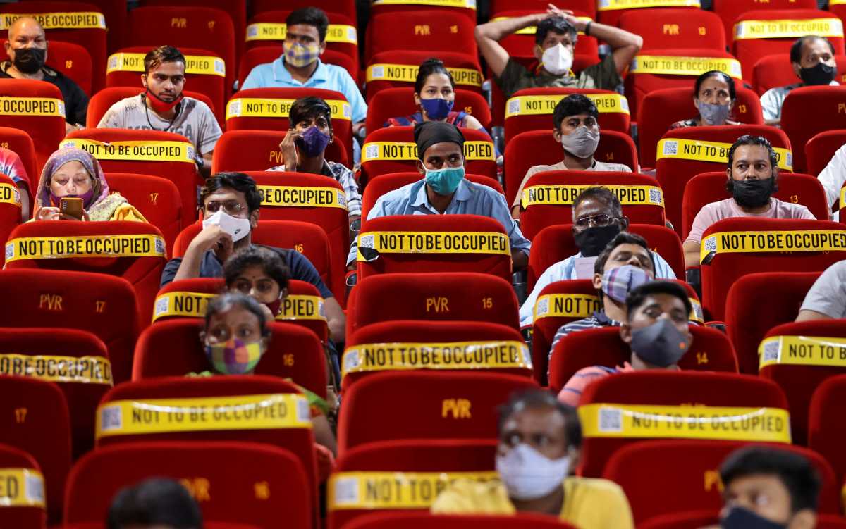 People wait to receive a dose of COVISHIELD, a vaccine against coronavirus disease (COVID-19) manufactured by Serum Institute of India, at a cinema hall in Mumbai, India, August 17, 2021. REUTERS