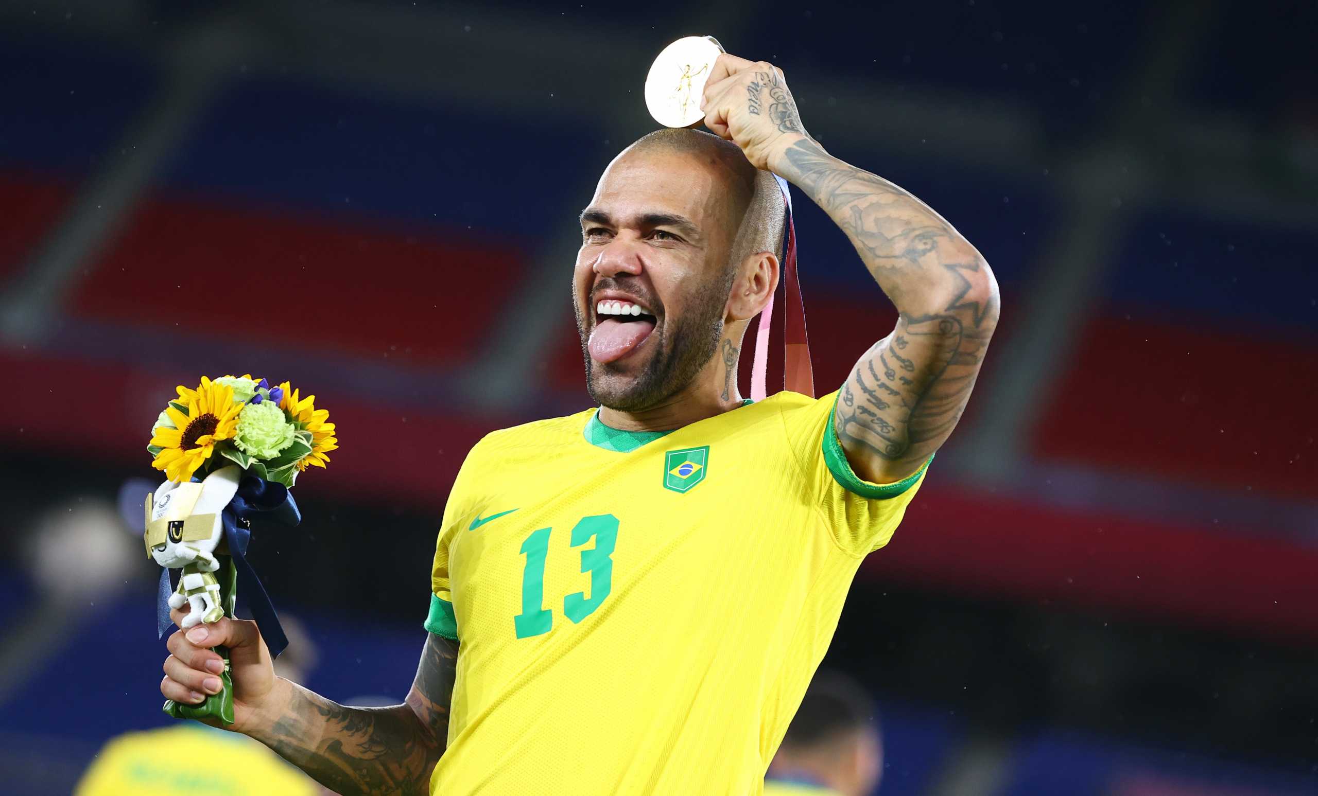 Tokyo 2020 Olympics - Soccer Football - Men's Team - Medal Ceremony - International Stadium Yokohama, Yokohama, Japan - August 7, 2021.  Dani Alves of Brazil as gold medallists Brazil celebrate during the medal ceremony. REUTERS