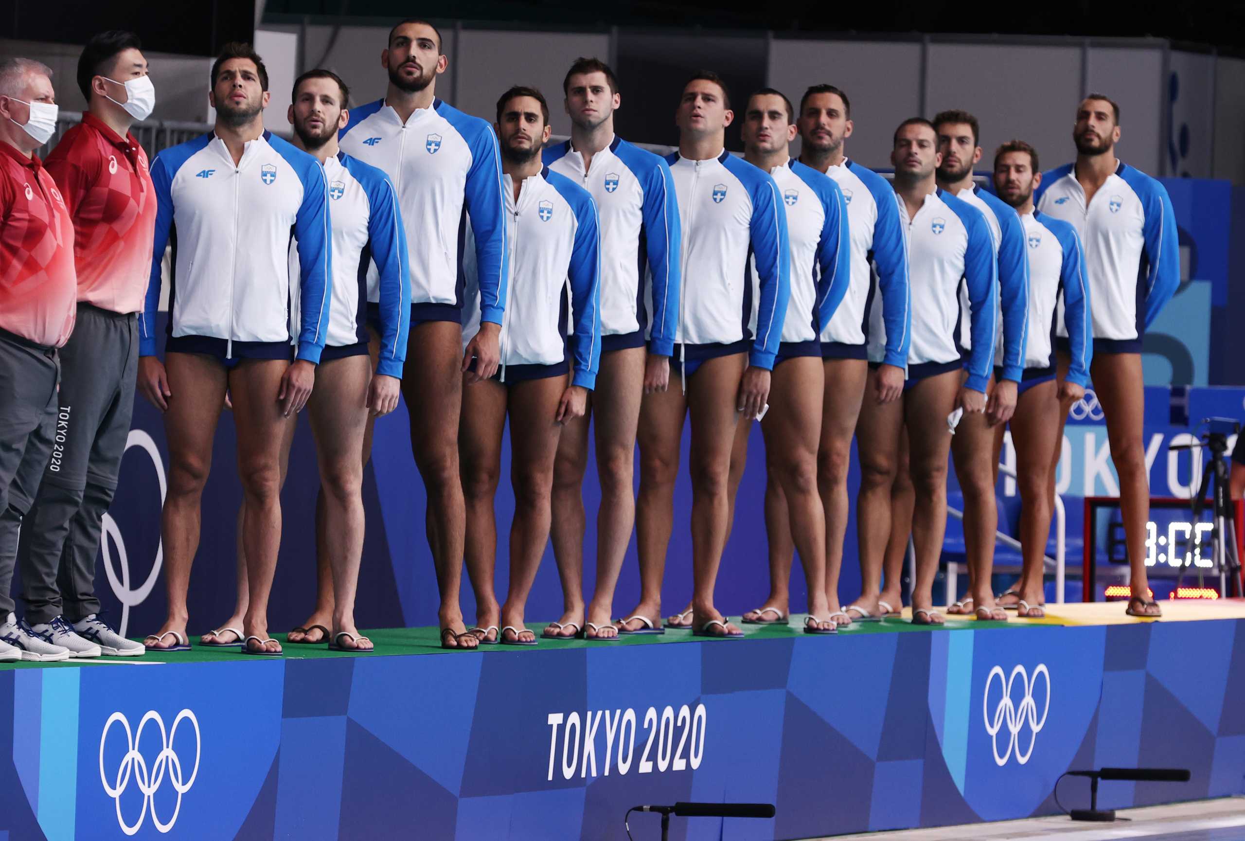 Tokyo 2020 Olympics - Water Polo - Men - Group A - South Africa v Greece - Tatsumi Water Polo Centre, Tokyo, Japan - July 31, 2021. Greece's team members listen to their national anthem ahead of the match. REUTERS