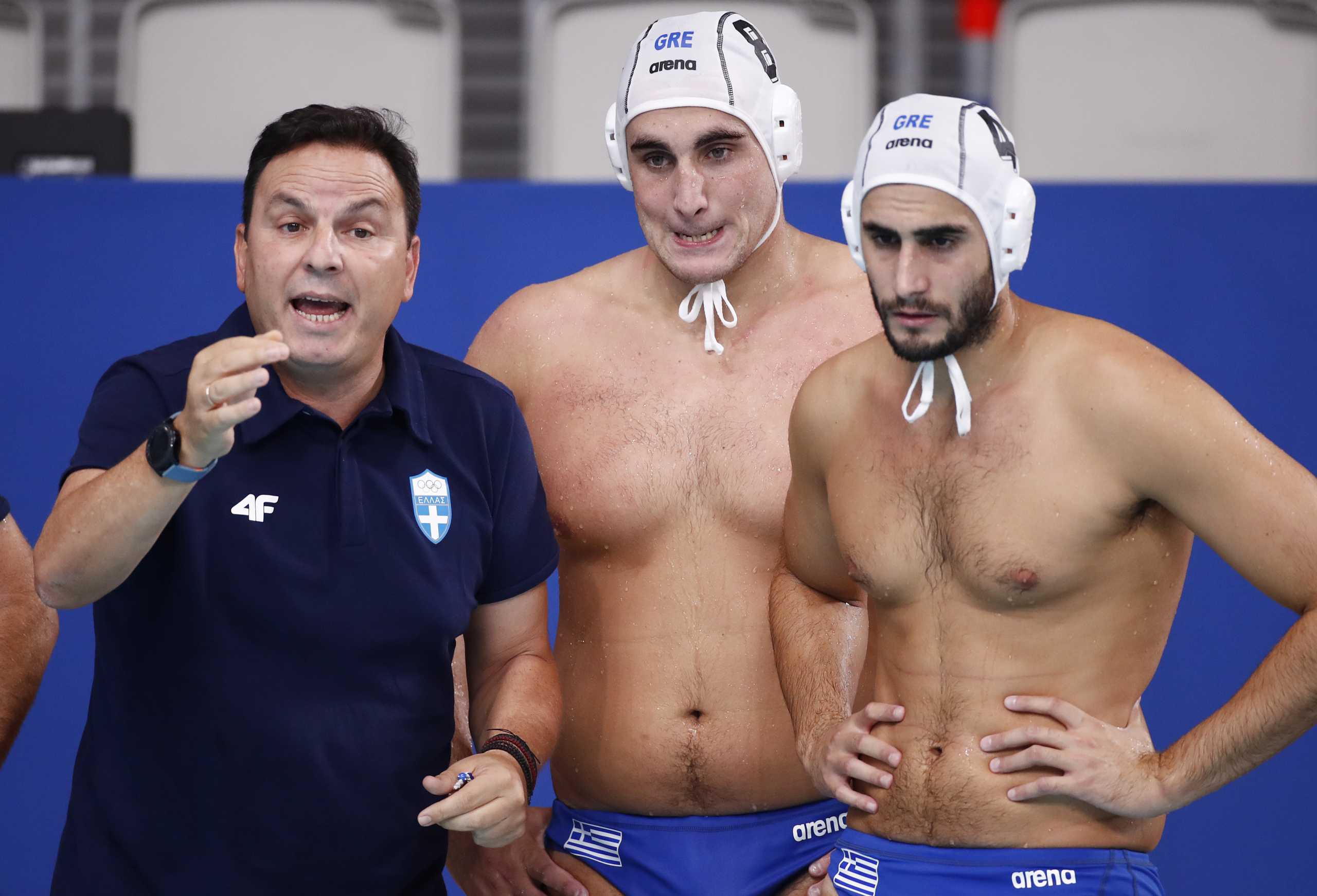 Tokyo 2020 Olympics - Water Polo - Men - Semifinal - Greece v Hungary -  Tatsumi Water Polo Centre, Tokyo, Japan – August 6, 2021. Greece's head coach Theodoros Vlachos speaks next to Stylianos Argyropoulos Kanakakis of Greece and Marios Kapotsis of Greece REUTERS