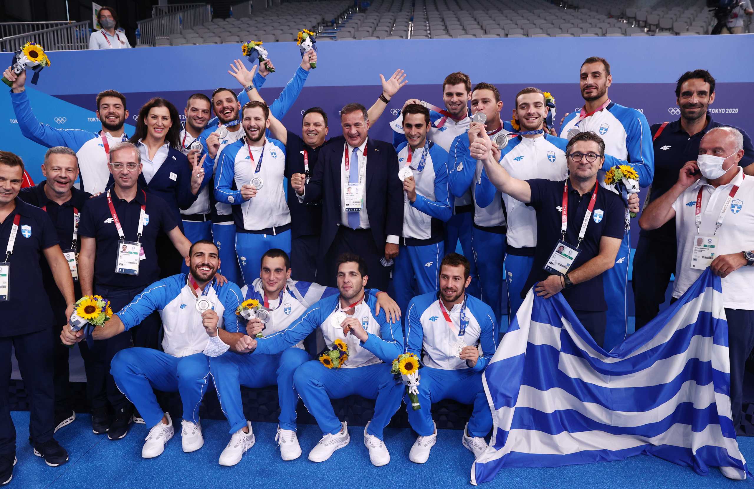 Tokyo 2020 Olympics - Water Polo - Men - Medal Ceremony - Tatsumi Water Polo Centre, Tokyo, Japan – August 8, 2021. Silver medallists, Greece's team members, pose for pictures with their national flag during medal ceremony REUTERS