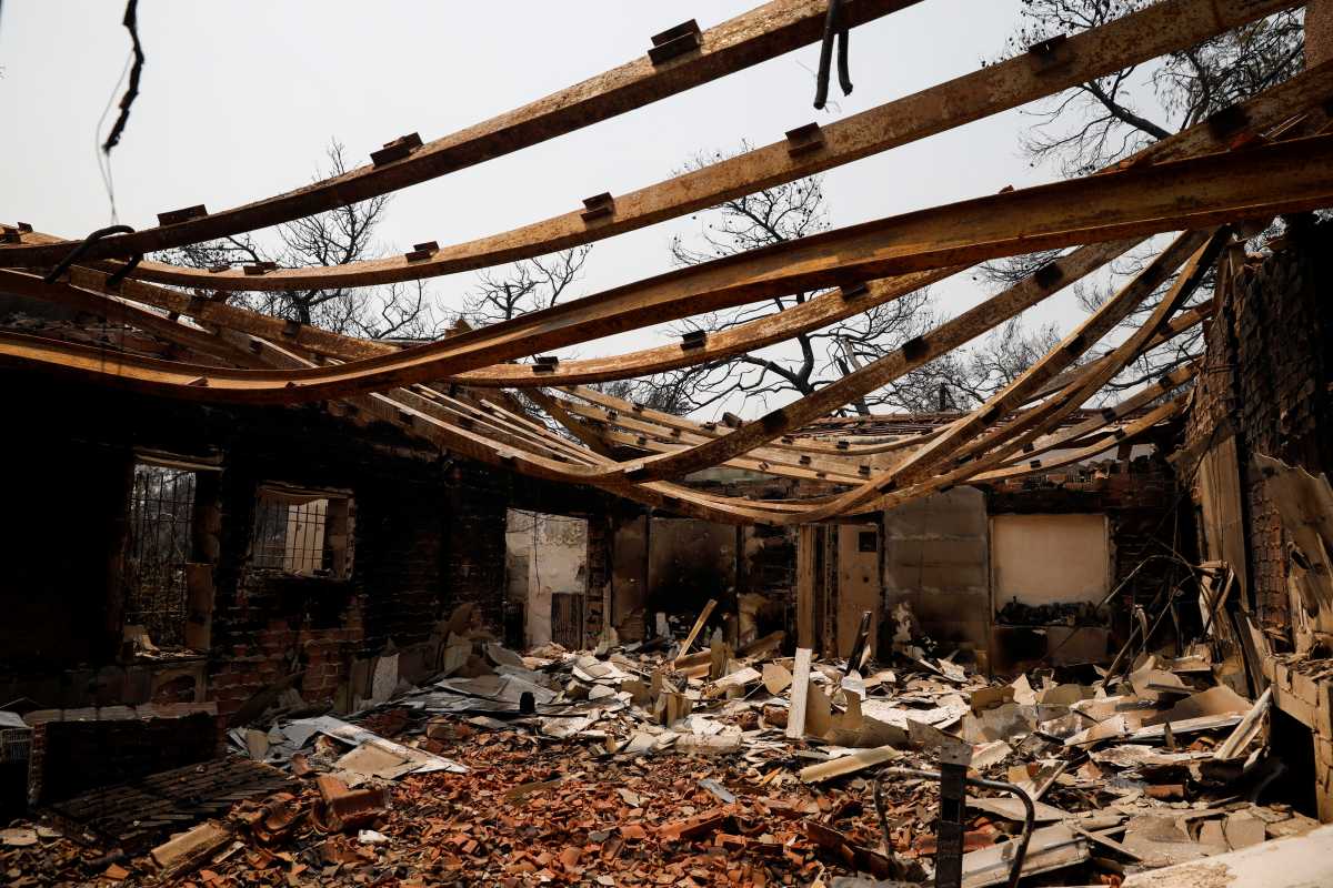 A burnt house is seen following a wildfire in Varympompi suburb, north of Athens, Greece, August 4, 2021. REUTERS