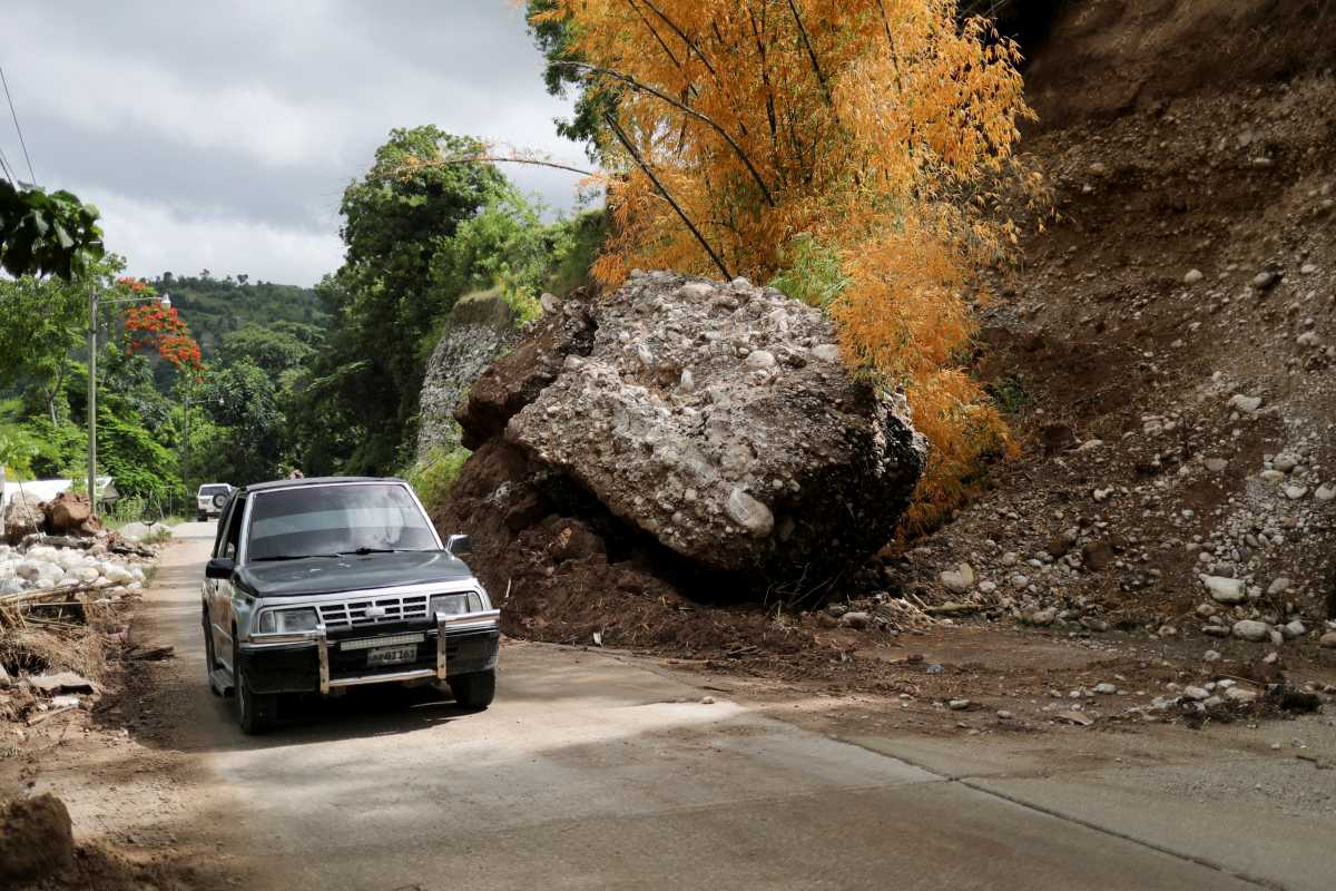 A car drives past a landslide on a road near Les Cayes after Saturday's 7.2 magnitude earthquake,  Haiti, August 18, 2021. REUTERS