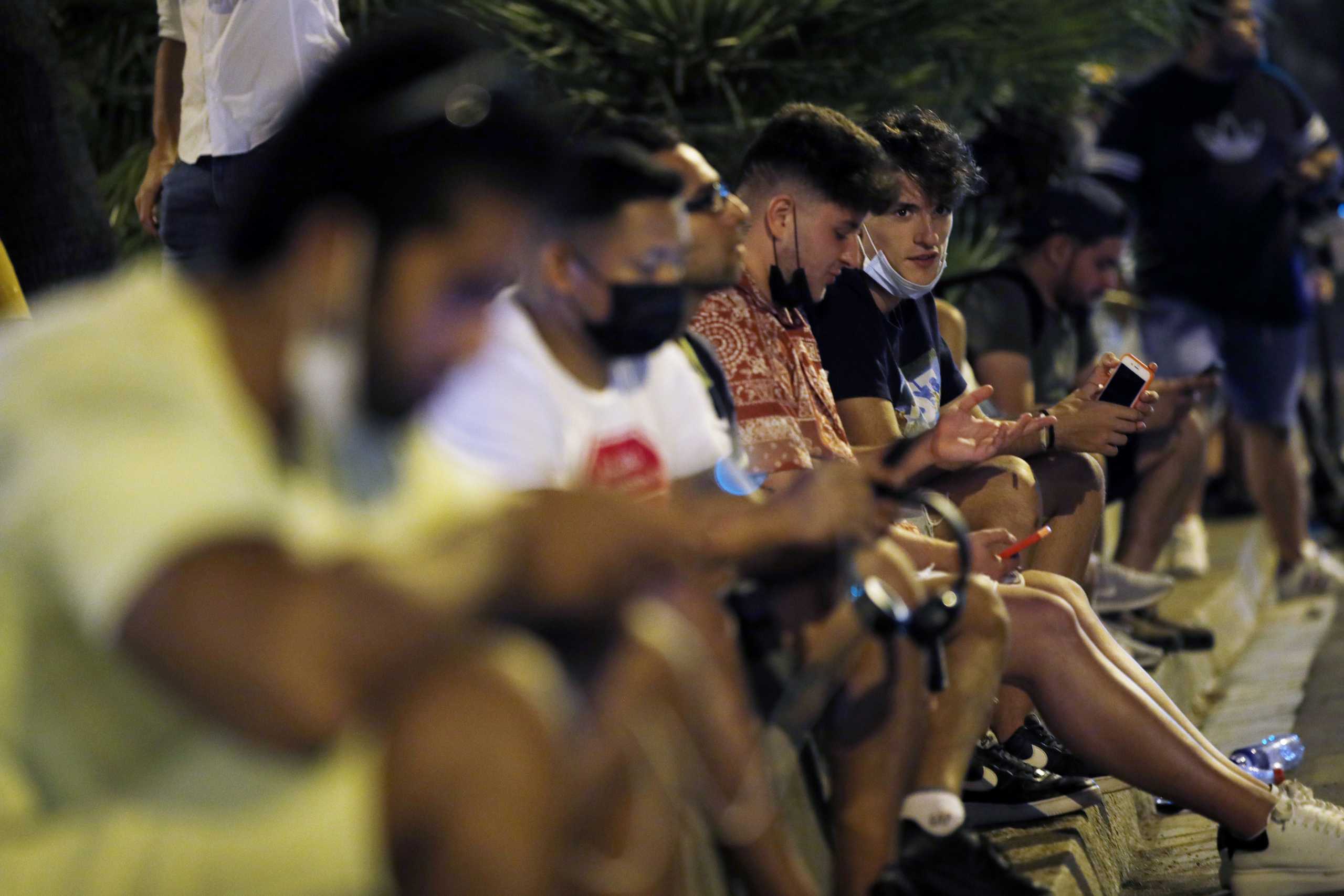 Soccer Football - FC Barcelona announce Lionel Messi will leave the club - Camp Nou, Barcelona, Spain - August 5, 2021 People check their mobile phones outside the Camp Nou after FC Barcelona announced Lionel Messi will leave the club REUTERS