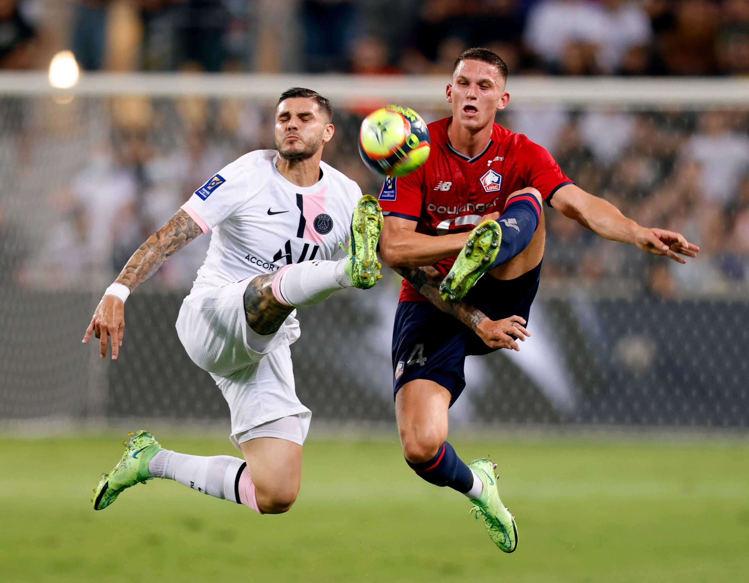 Soccer Football - Trophee des Champions - Lille v Paris St Germain - Bloomfield Stadium, Tel Aviv, Israel - August 1, 2021 Paris St Germain's Mauro Icardi in action with Lille's Sven Botman REUTERS