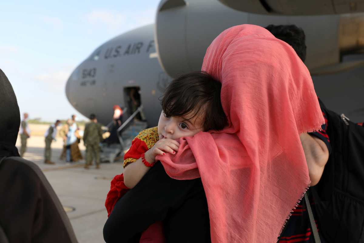 Evacuees from Afghanistan watch others disembark the aircraft after arriving at Naval Station (NAVSTA) Rota, Spain August 27, 2021. Picture taken August 27, 2021.  U.S. Navy