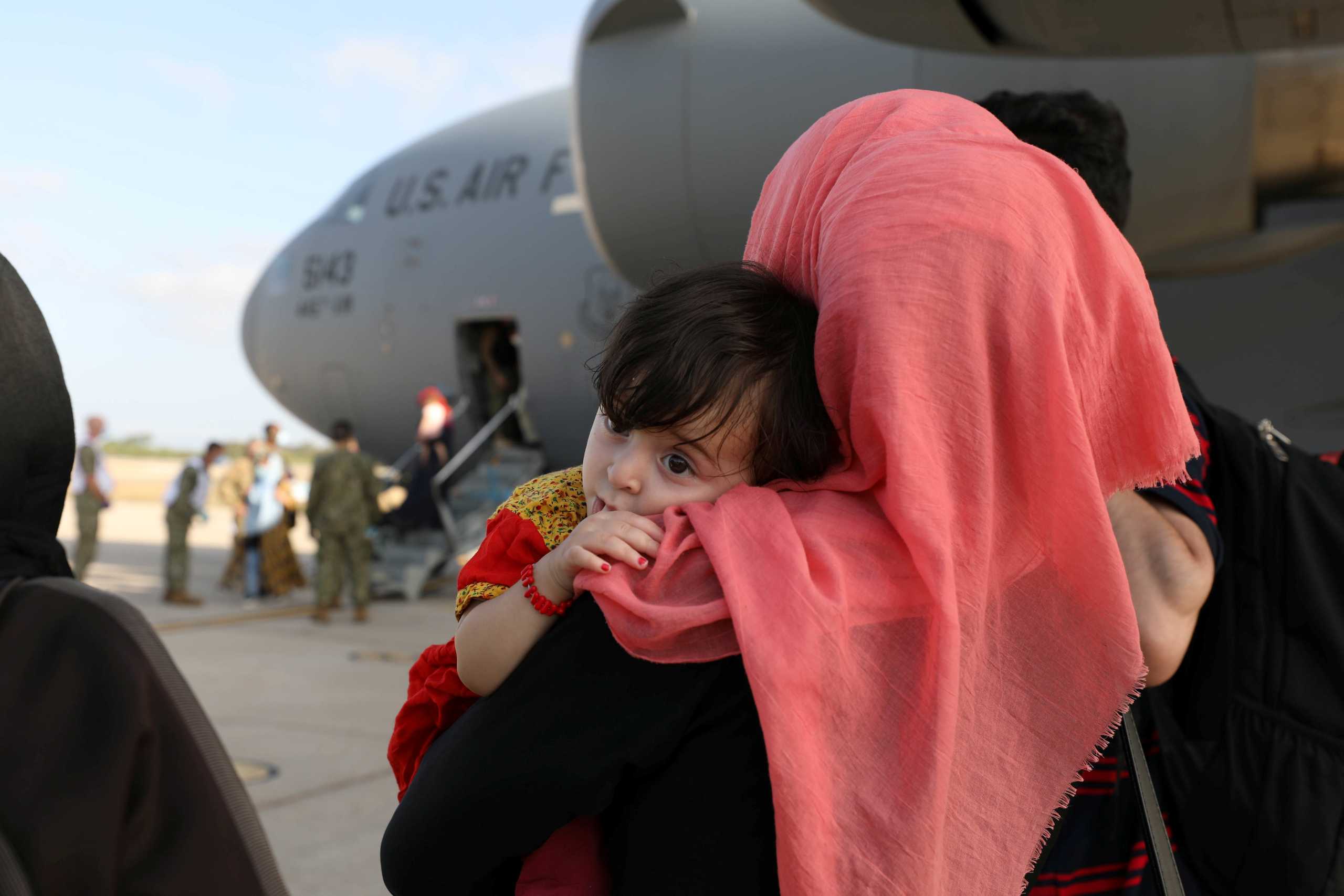 Evacuees from Afghanistan watch others disembark the aircraft after arriving at Naval Station (NAVSTA) Rota, Spain August 27, 2021. Picture taken August 27, 2021.  U.S. Navy