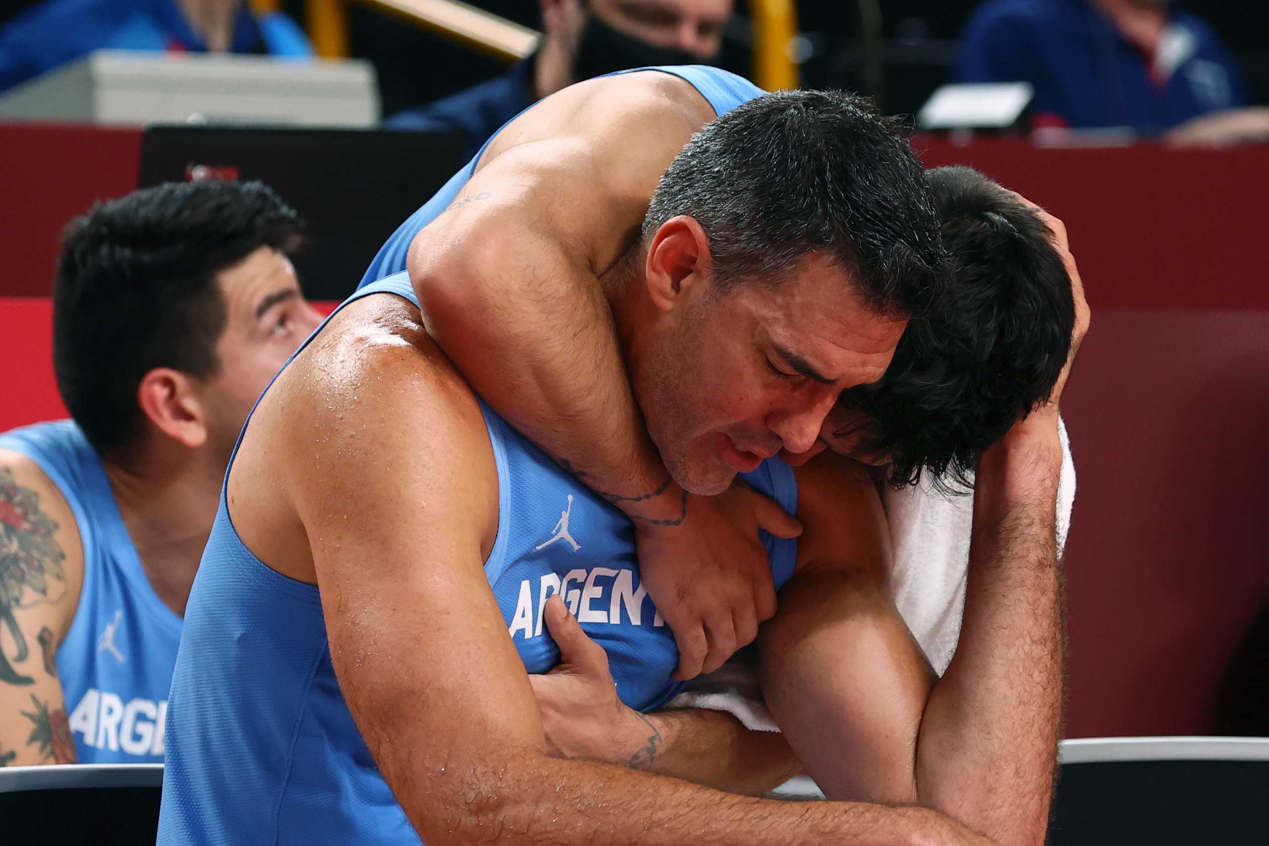 Tokyo 2020 Olympics - Basketball - Men - Quarterfinal - Australia v Argentina - Saitama Super Arena, Saitama, Japan - August 3, 2021. Facundo Campazzo of Argentina hugs Luis Scola of Argentina REUTERS