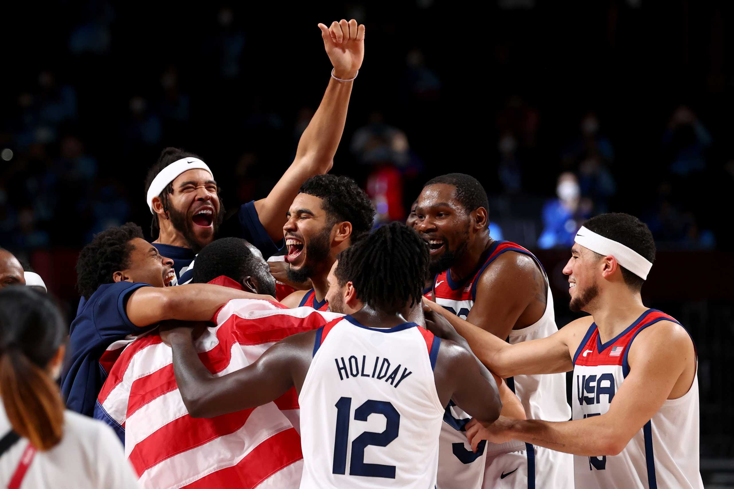 Tokyo 2020 Olympics - Basketball - Men - Gold medal match - France v United States - Saitama Super Arena, Saitama, Japan - August 7, 2021. United States players celebrate with teammates after winning the gold medal match against France REUTERS