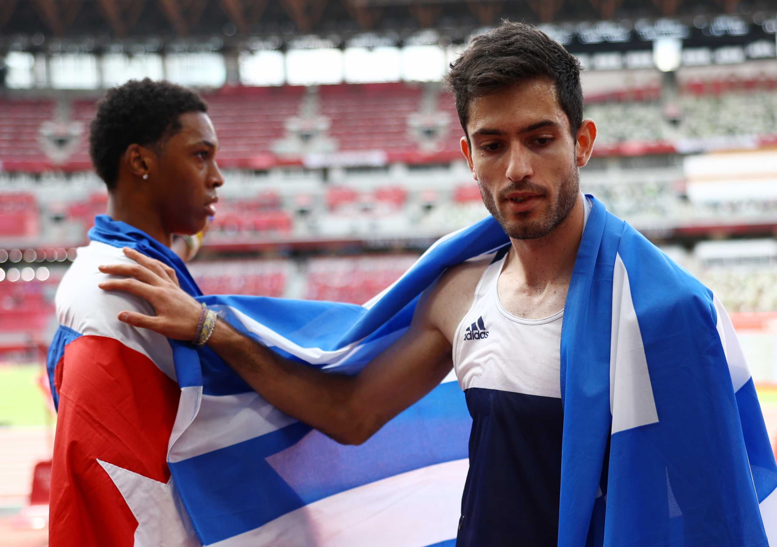 Tokyo 2020 Olympics - Athletics - Men's Long Jump - Final - Olympic Stadium, Tokyo, Japan - August 2, 2021. Gold medallist Miltiadis Tentoglou of Greece celebrates with silver medallist, Juan Miguel Echevarria of Cuba REUTERS