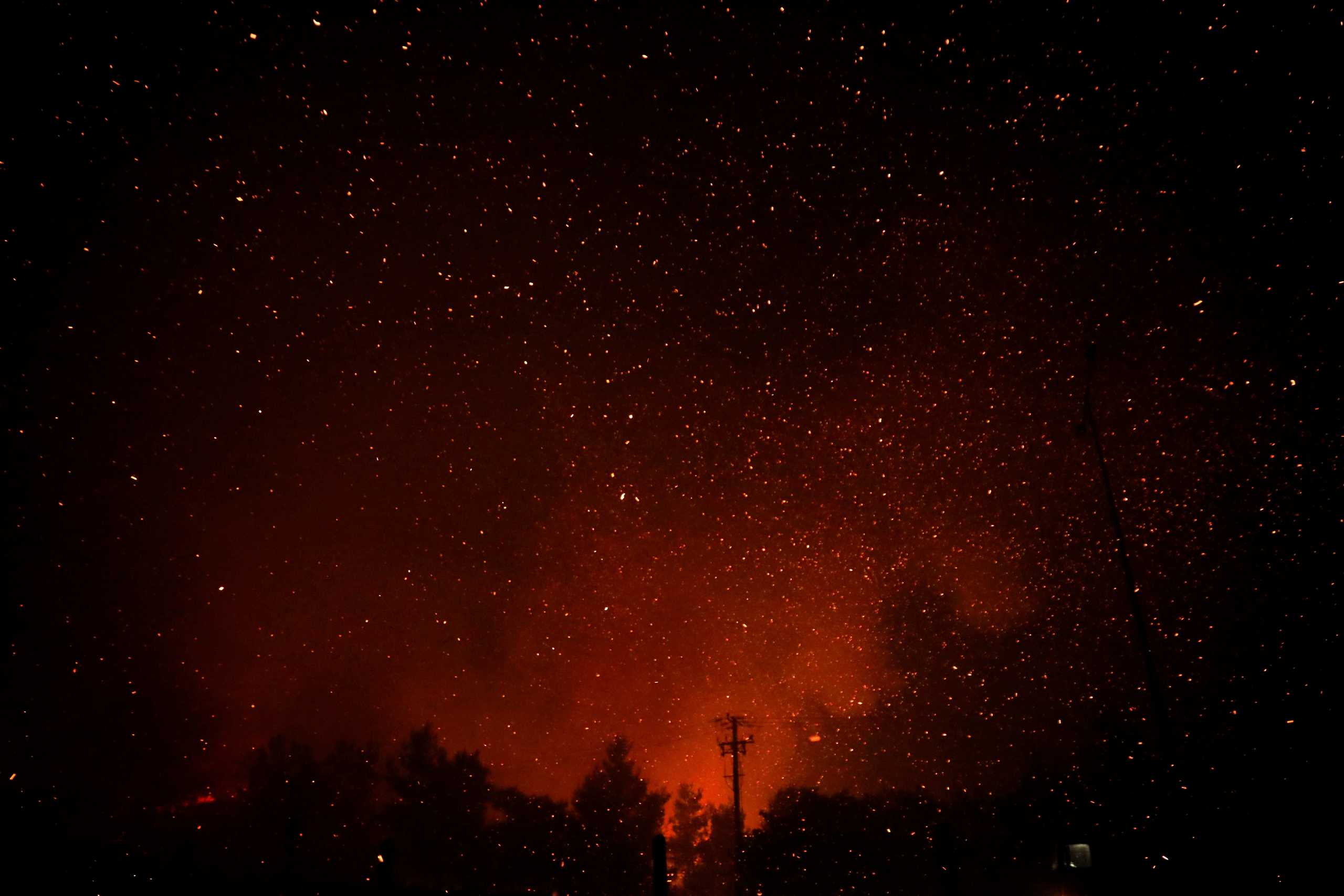 Sparks illuminate the sky as a wildfire rages near Afidnes, north of Athens, Greece August 5, 2021. REUTERS