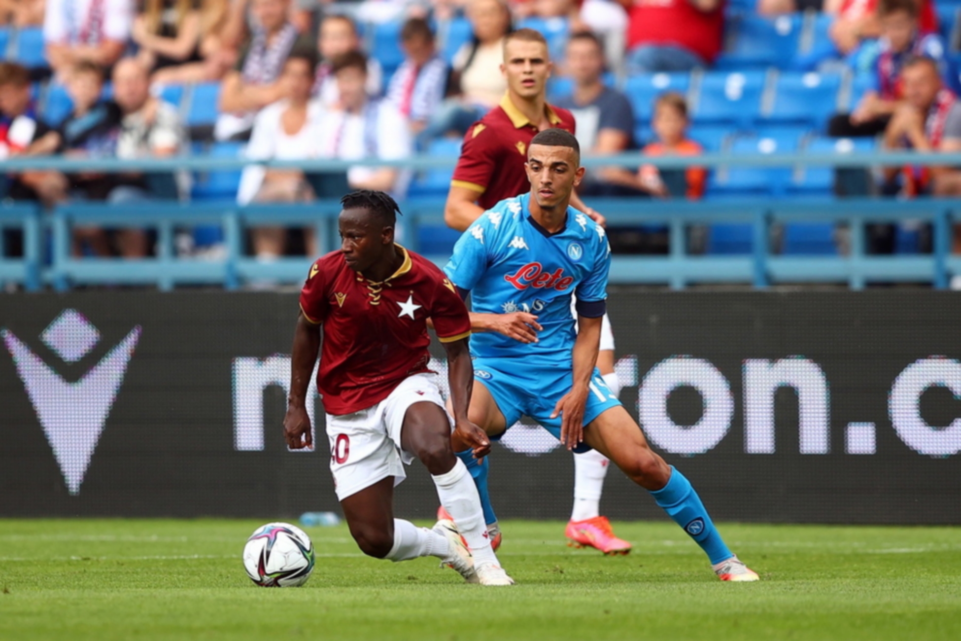 epa09395873 Yaw Yeboah (L) of Wisla Krakow and Karim Zedadka (R) of SSC Napoli in action during the friendly match between Wisla Krakow and SSC Napoli in Krakow, Poland, 04 August 2021. The match was played on the occasion of 115th anniversary of the club Wisla Krakow.  EPA