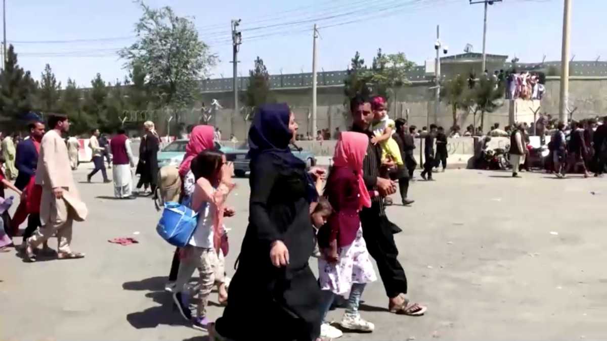People gather outside Kabul airport, Afghanistan August 16, 2021, in this still image taken from a video. REUTERS TV