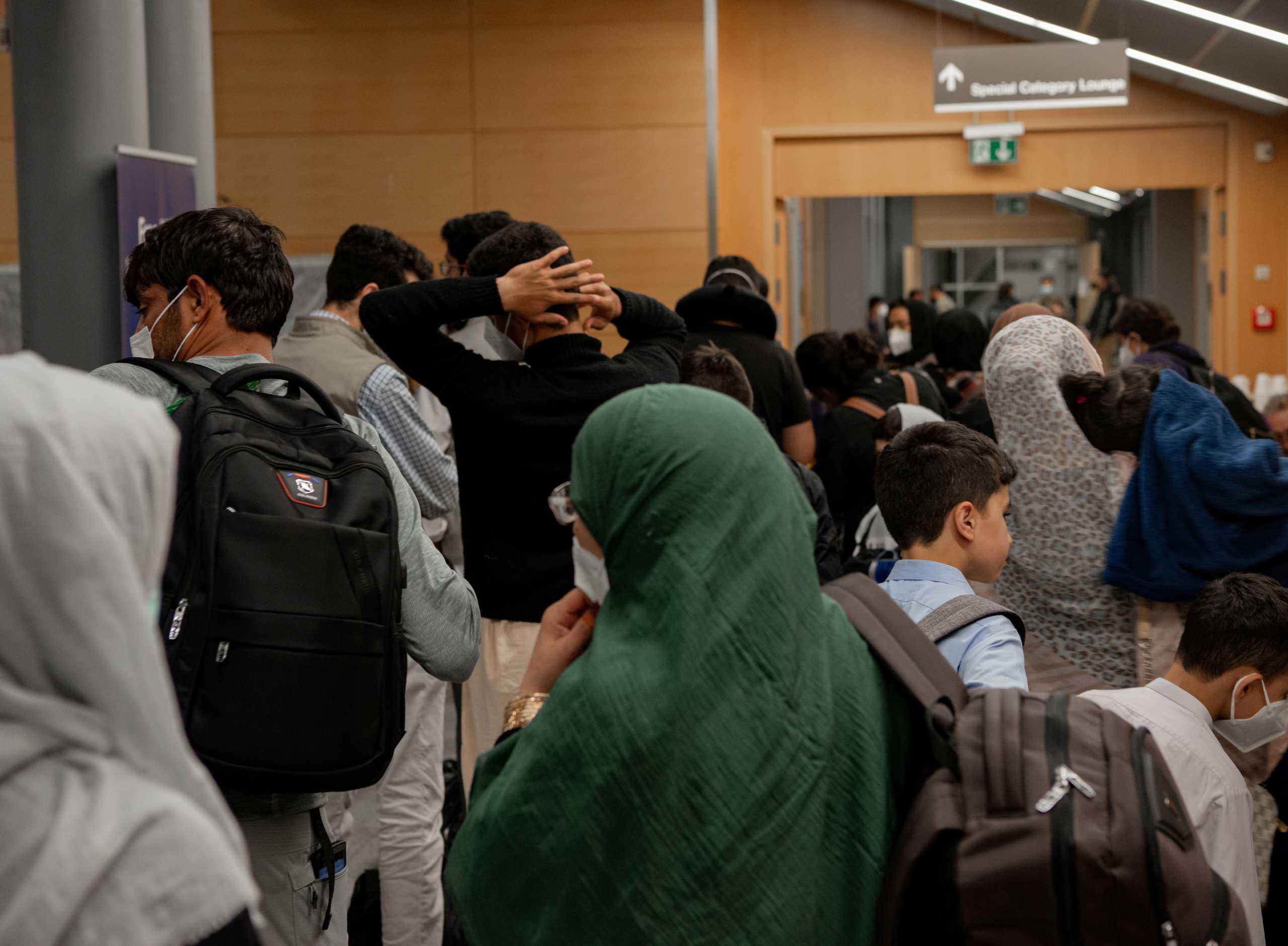 U.S. citizens and their families process through the passenger terminal at Ramstein Air Base to board a departure flight on their way to the United States as part of Operations Allies Refuge, Germany, August 23, 2021. Airman Edgar Grimaldo