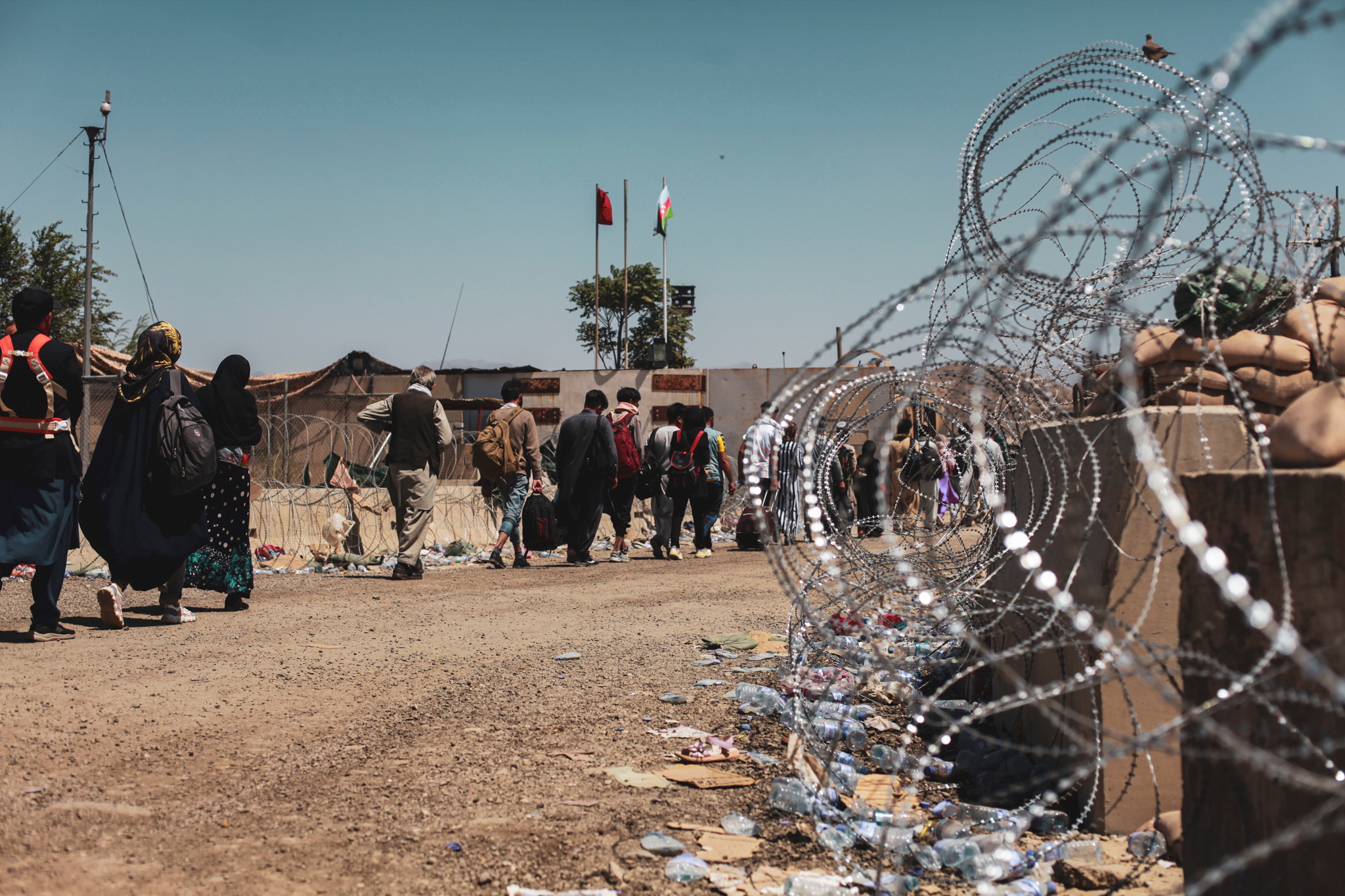Evacuees walk to be processed during an evacuation at Hamid Karzai International Airport, Kabul, Afghanistan, August 25, 2021. Picture taken August 25, 2021.  U.S. Marine Corps