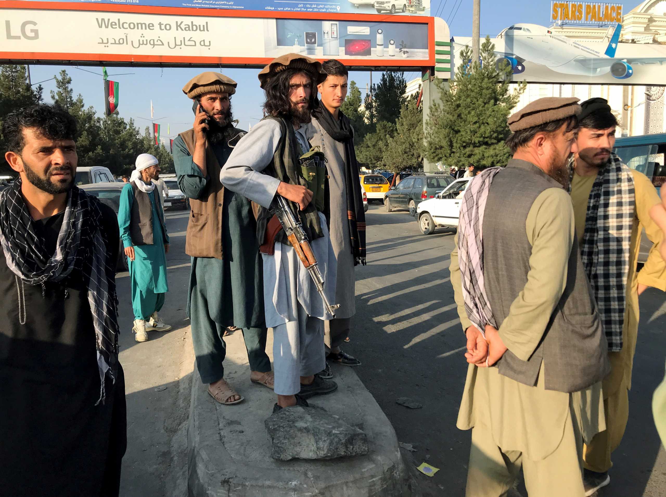 Taliban fighters stand outside Hamid Karzai International Airport in Kabul, Afghanistan, August 16, 2021. REUTERS