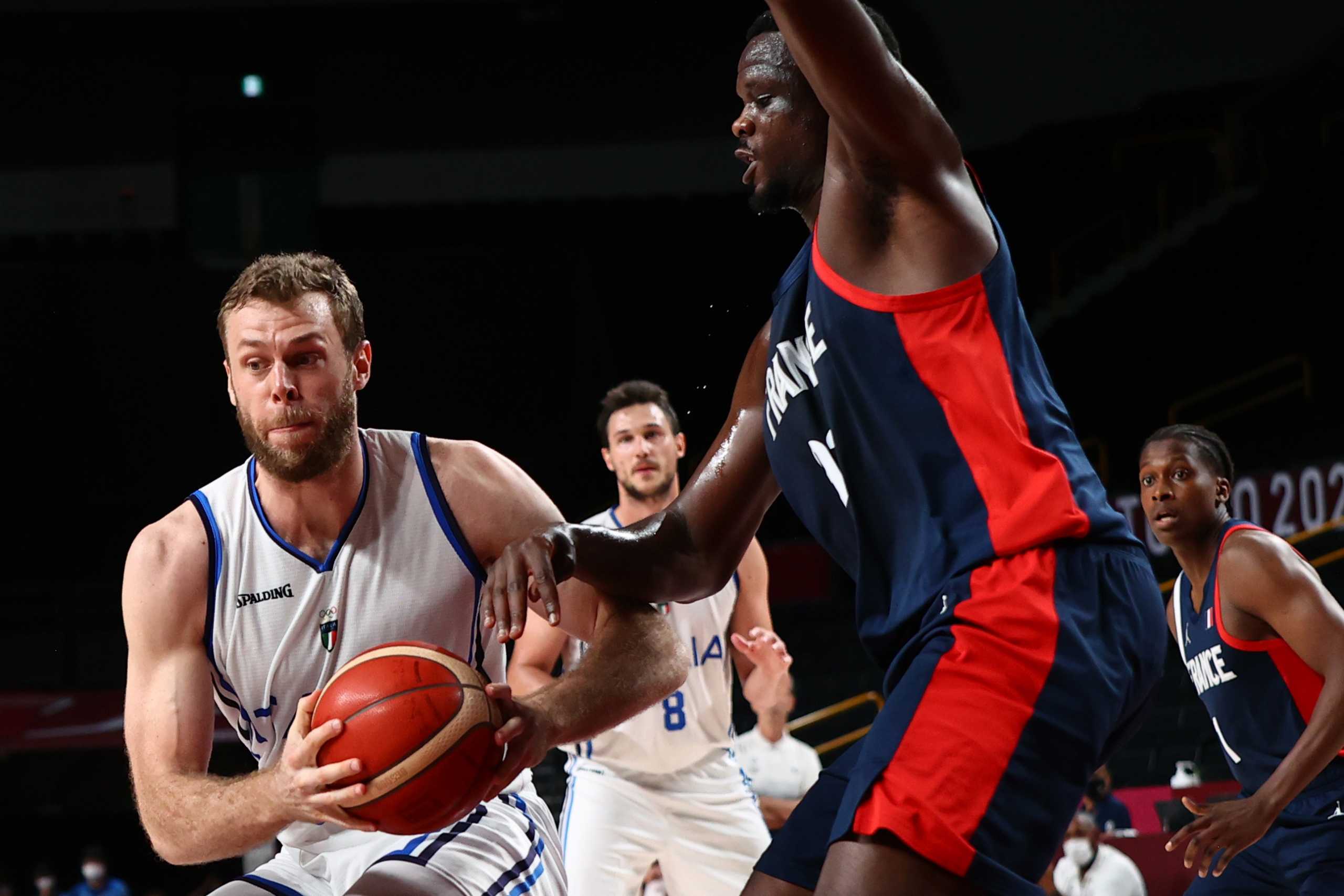 Tokyo 2020 Olympics - Basketball - Men - Quarterfinal - Italy v France - Saitama Super Arena, Saitama, Japan - August 3, 2021. Niccolo Melli of Italy in action with Moustapha Fall of France REUTERS