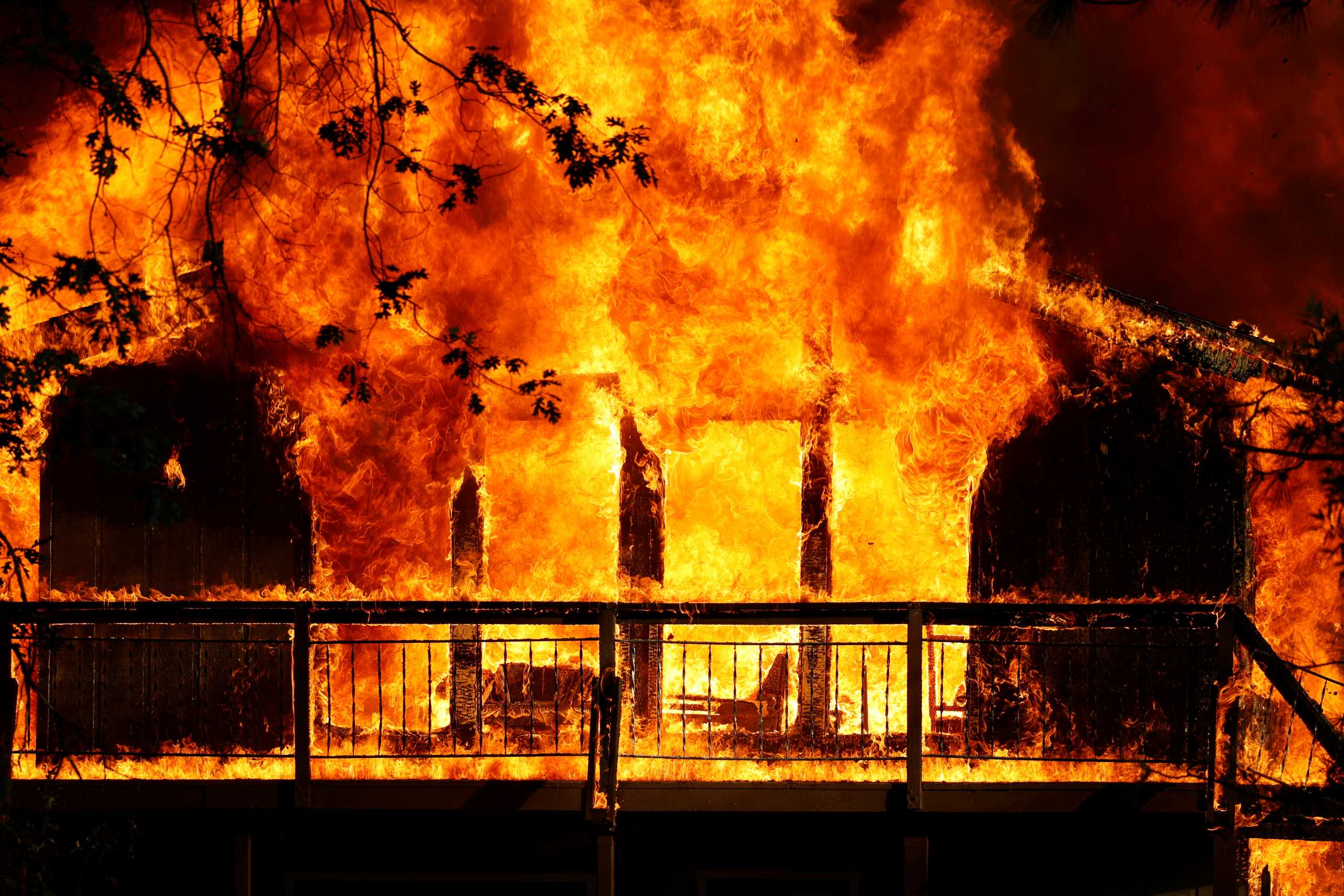A home is consumed by flames in the River Fire, a wildfire burning in Grass Valley, California, U.S., August 4, 2021. REUTERS