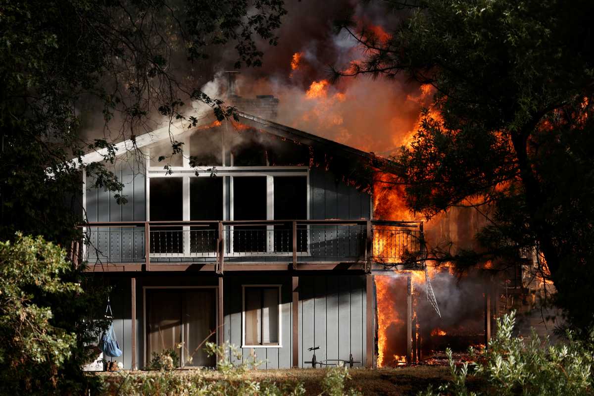 A home is consumed by flames in the River Fire, a wildfire burning in Grass Valley, California, U.S., August 4, 2021. REUTERS