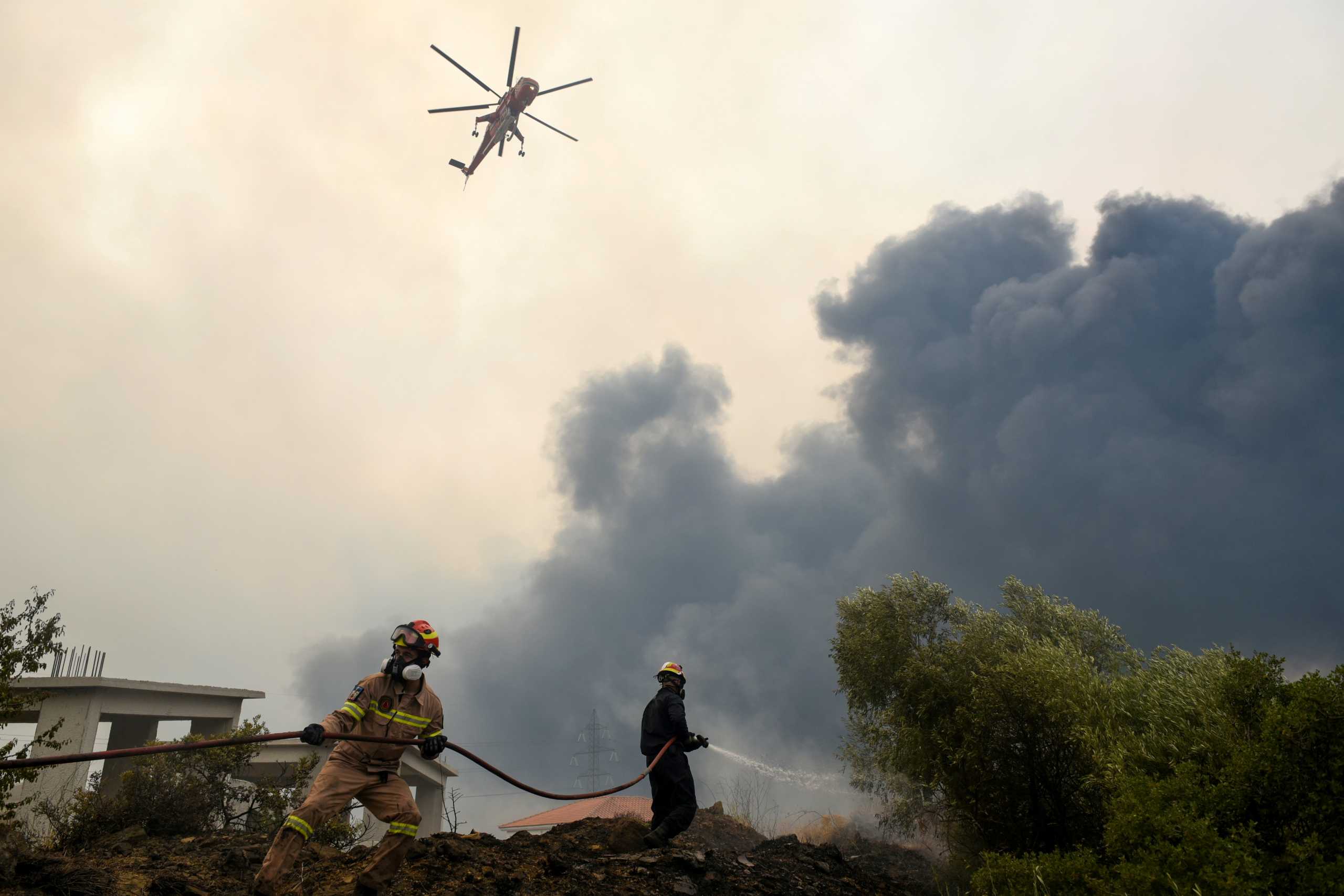 FILE PHOTO: Firefighters try to extinguish fires as a wildfire continues to rage near the village of Afidnes, north of Athens, Greece, August 6, 2021. REUTERS