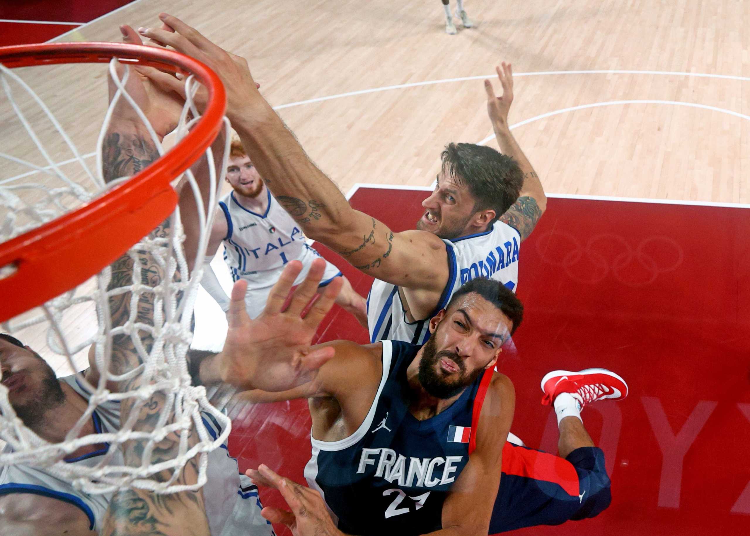 Tokyo 2020 Olympics - Basketball - Men - Quarterfinal - Italy v France - Saitama Super Arena, Saitama, Japan - August 3, 2021. Rudy Gobert of France in action at the rim with Achille Polonara of Italy and Danilo Gallinari of Italy Pool via REUTERS