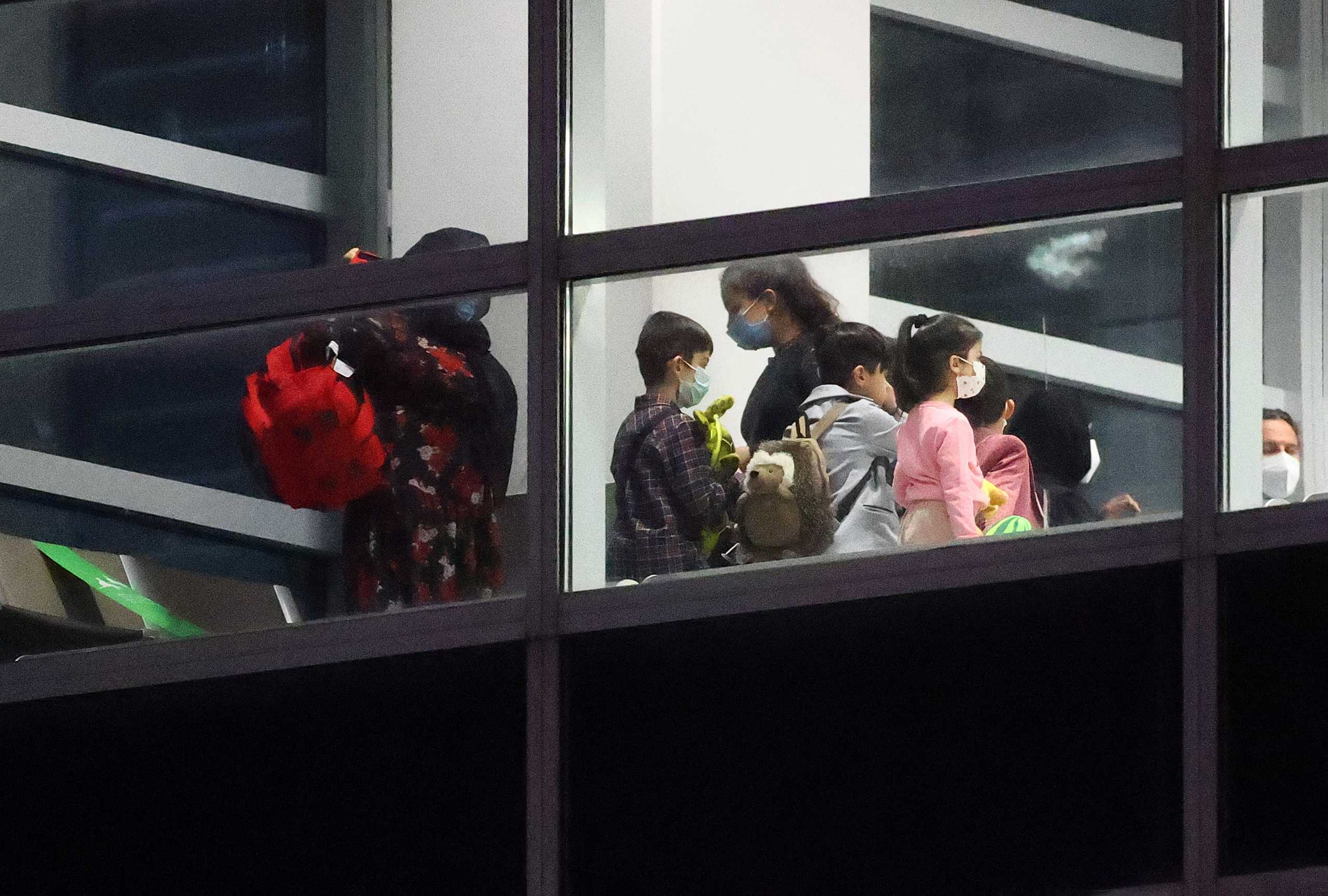 Women and children wait for a document check after disembarking from the last plane arriving with Afghan refugees via Tashkent at the airport in Frankfurt, Germany, August 27, 2021.  REUTERS