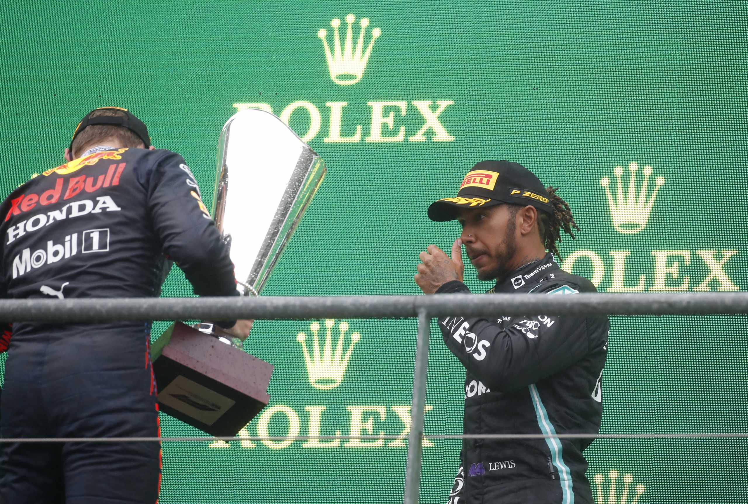 Formula One F1 - Belgian Grand Prix - Spa-Francorchamps, Spa, Belgium - August 29, 2021 Red Bull's Max Verstappen celebrates his first place with trophy on the podium as Mercedes' Lewis Hamilton looks on REUTERS